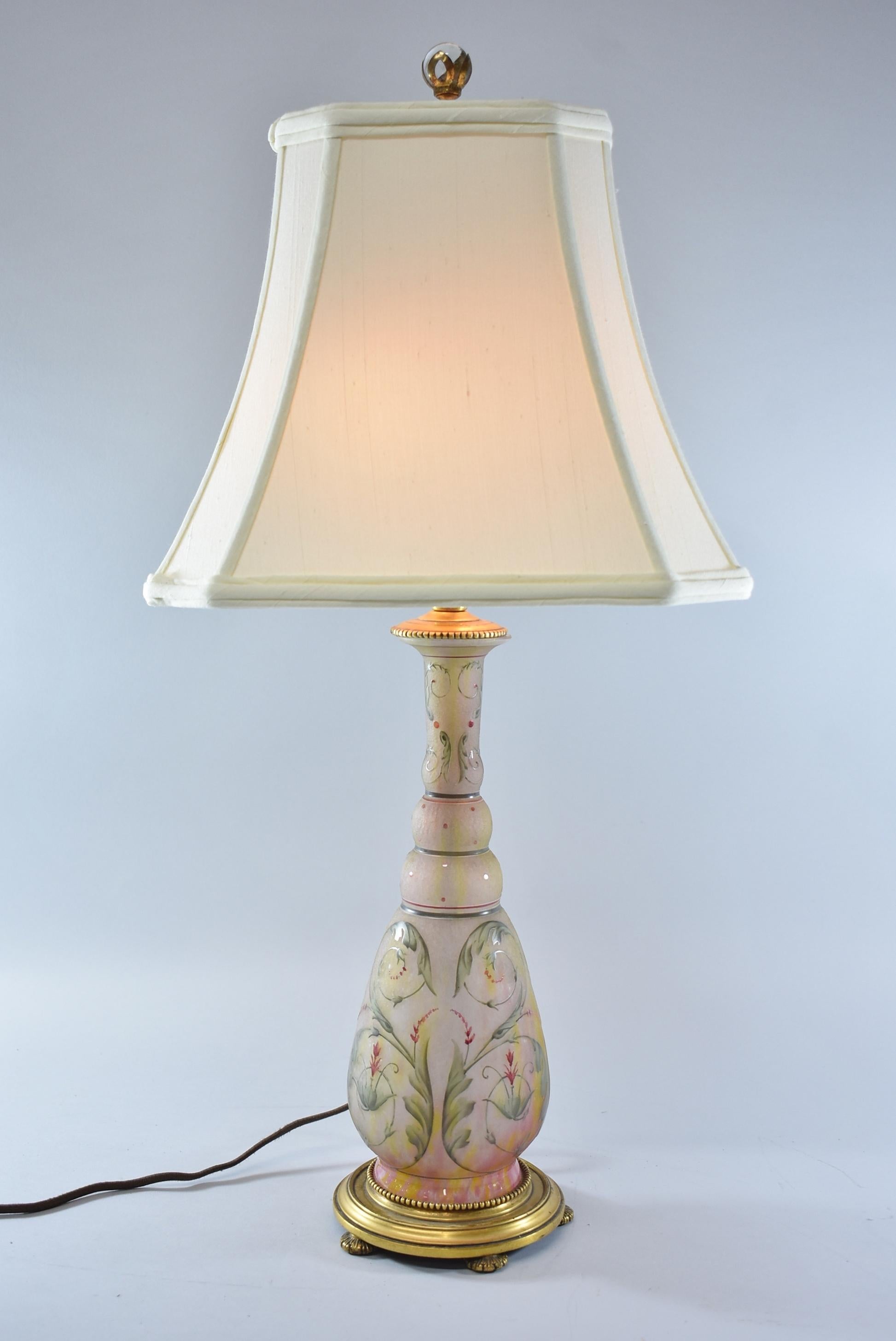 Beautiful art glass table lamp with double socket by Daum Nancy France. Acid cut and hand decorated with pink floral details and swirling leaf patterns. Brass mount base has a gold doré finish. Signed on the base.