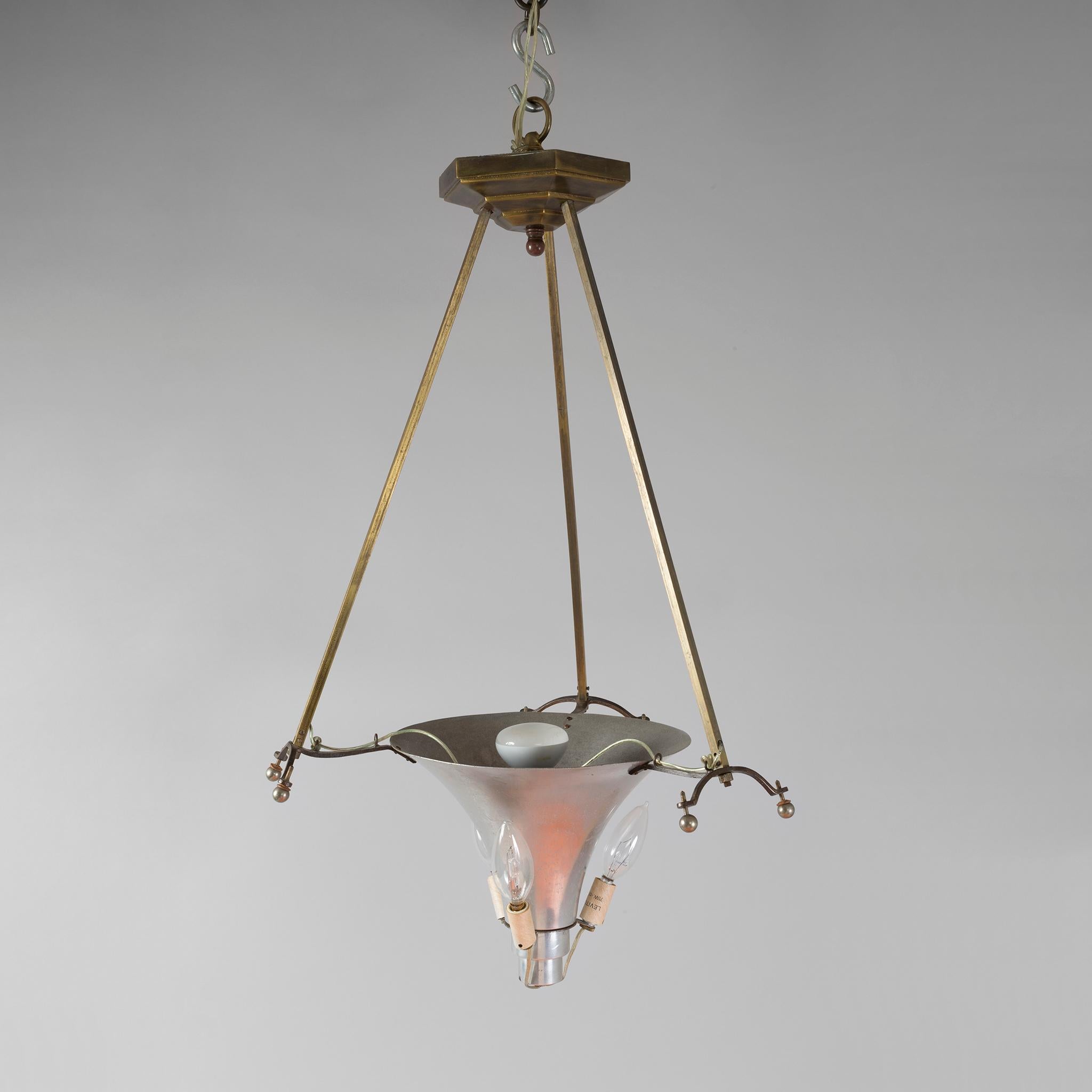 This beautiful chandelier, an superb example of French Art Deco by Daum Nancy, features a reverse bell-shaped shade hangs from three resolute arms in this wonderfully warm and perfectly detailed piece. The richly honey-colored shade is decorated