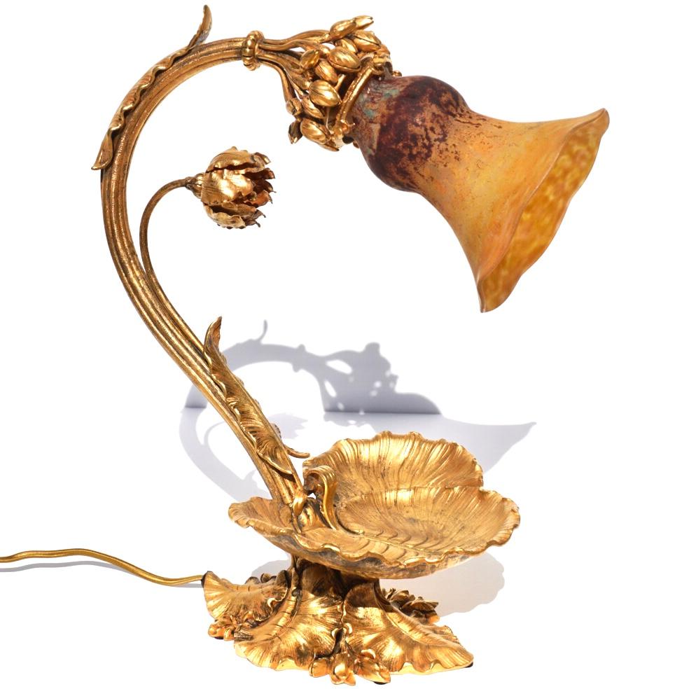 Daum Nancy French Art Nouveau Table Lamp. Circa 1900

Antique Art Nouveau French gilt bronze floral formed table lamp with Daum Nancy Mottled glass shade. The special shade speaks for itself and is in pristine condition emitting golds, purples, reds