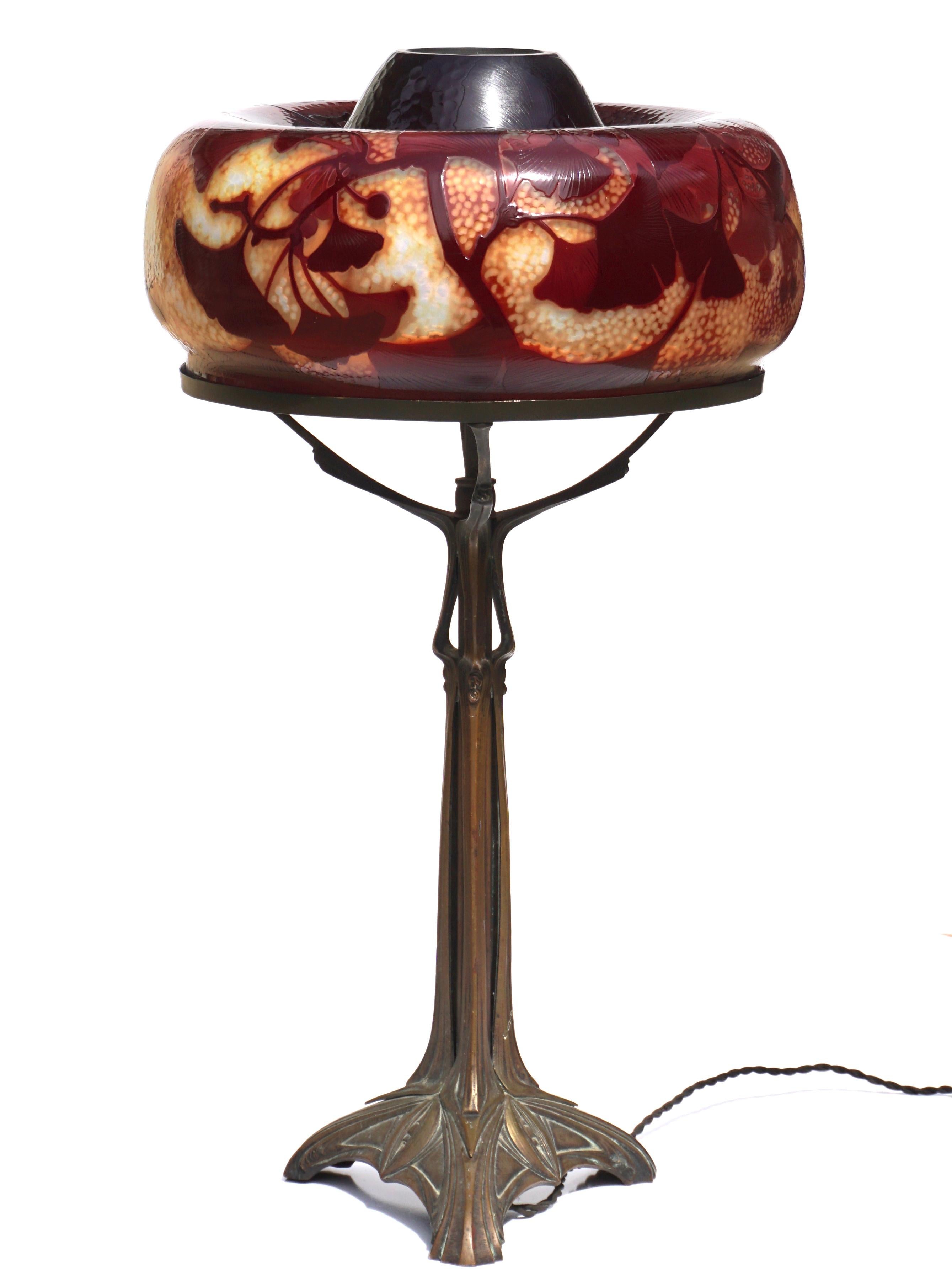 A large Daum Nancy French cameo glass lamp with martele designs of red and burgundy ginkgo biloba leaves on a hammered cream and yellow background, Circa 1900.

This marvelous and rare lamp is larger that life. The 12.5 diameter throws you off due