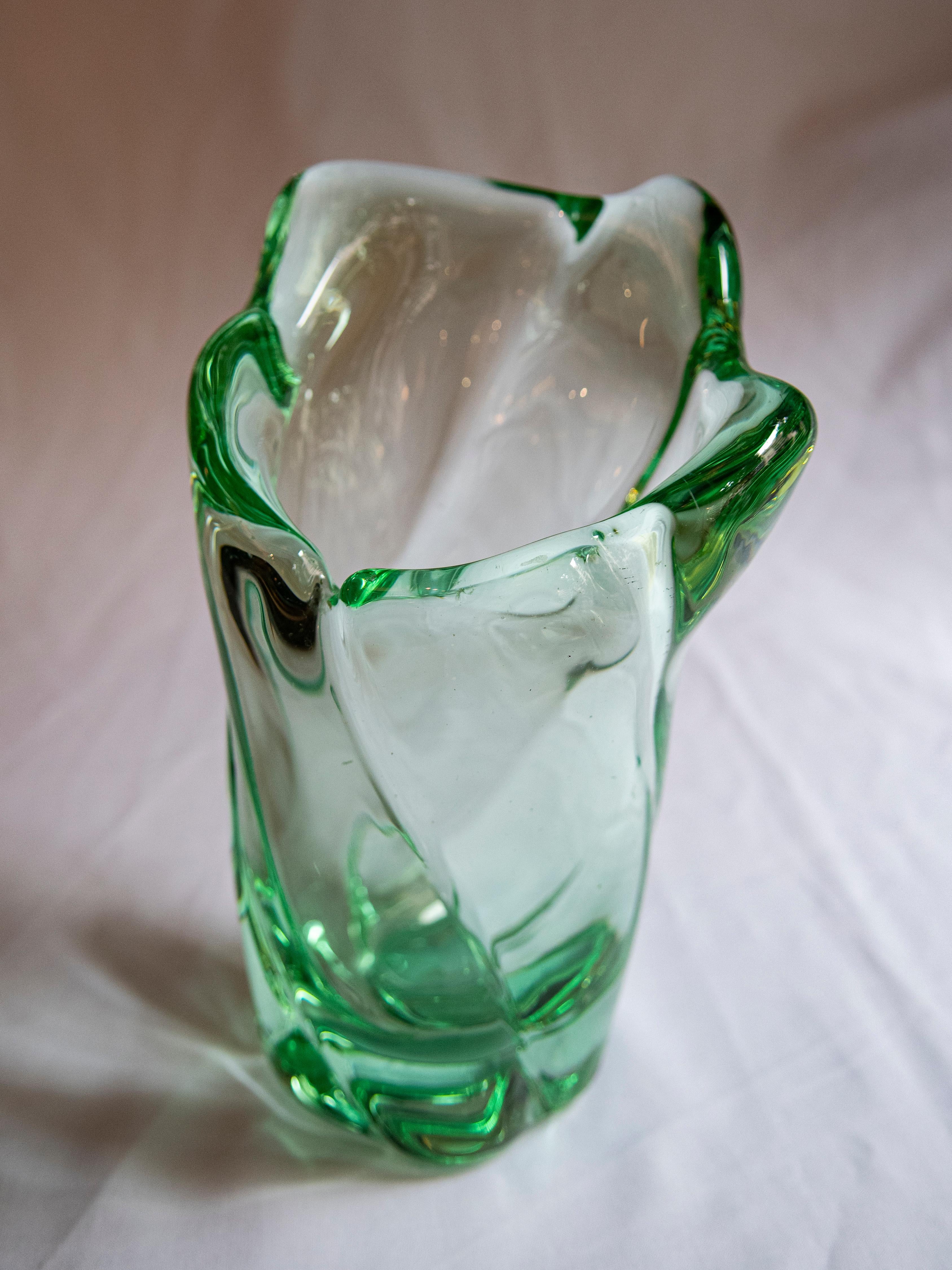 Daum Nancy transparent green vase with irregular form, circa 1950.
Signed on the base in intaglio with the cross of lorraine, France.
   