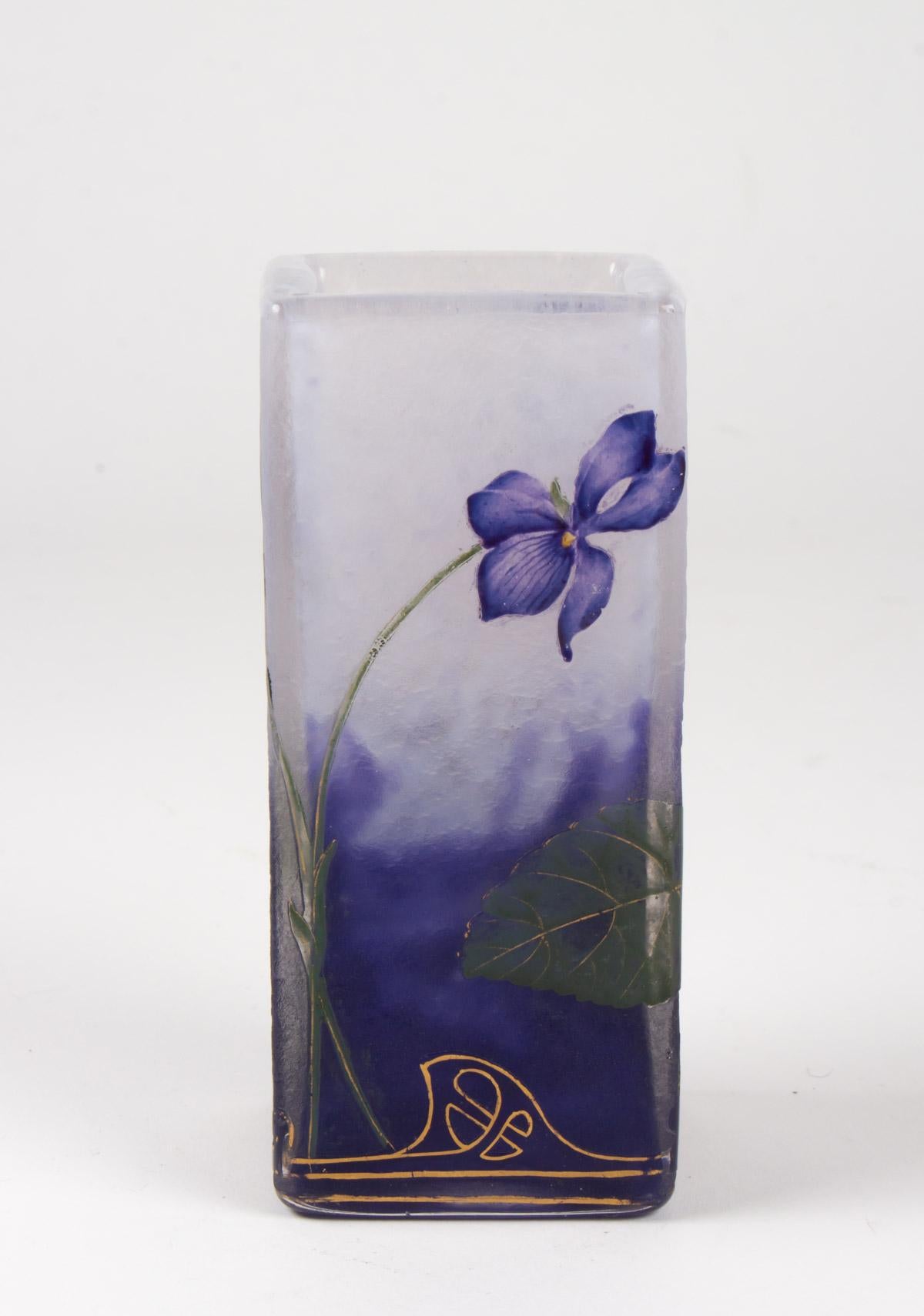 Daum, Nancy, circa 1900, clear glass with fleecy white and violet inclusions, the exterior with all-round etched violet motifs decorated in coloured enamel and gold, Gold signature Daum Nancy with Cross of Lorraineunder the base , height 12.