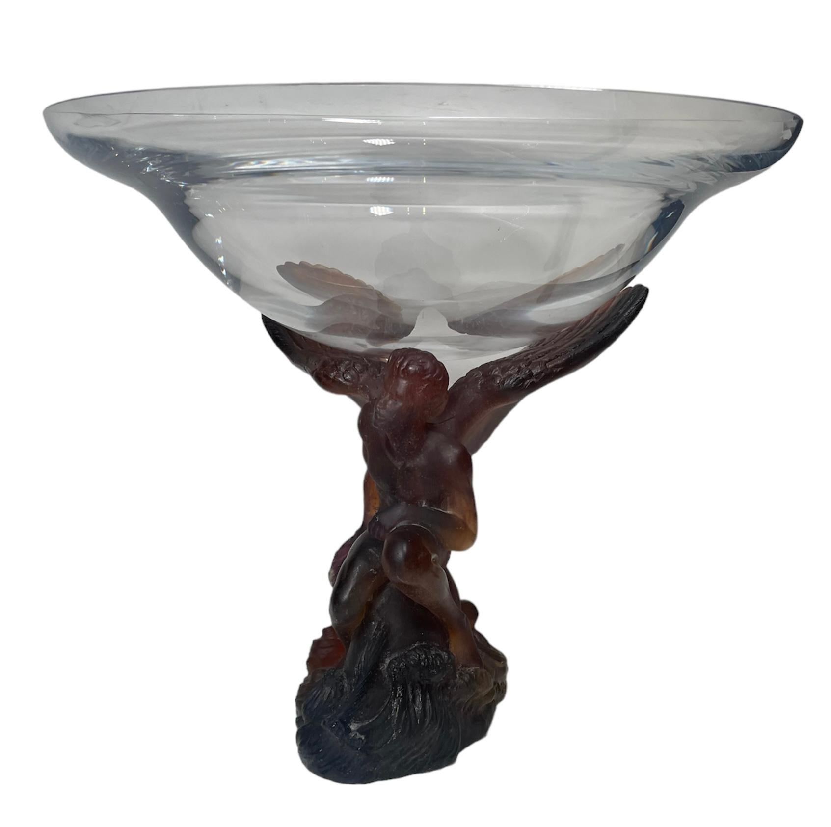 This is a Daum Pate de Verre Crystal Angel Sculpture compote/bowl. It depicts an amber brown color kneeling angel with big wings that serve to support the clear glass bowl. The sculpture is signed Daum France in the back.