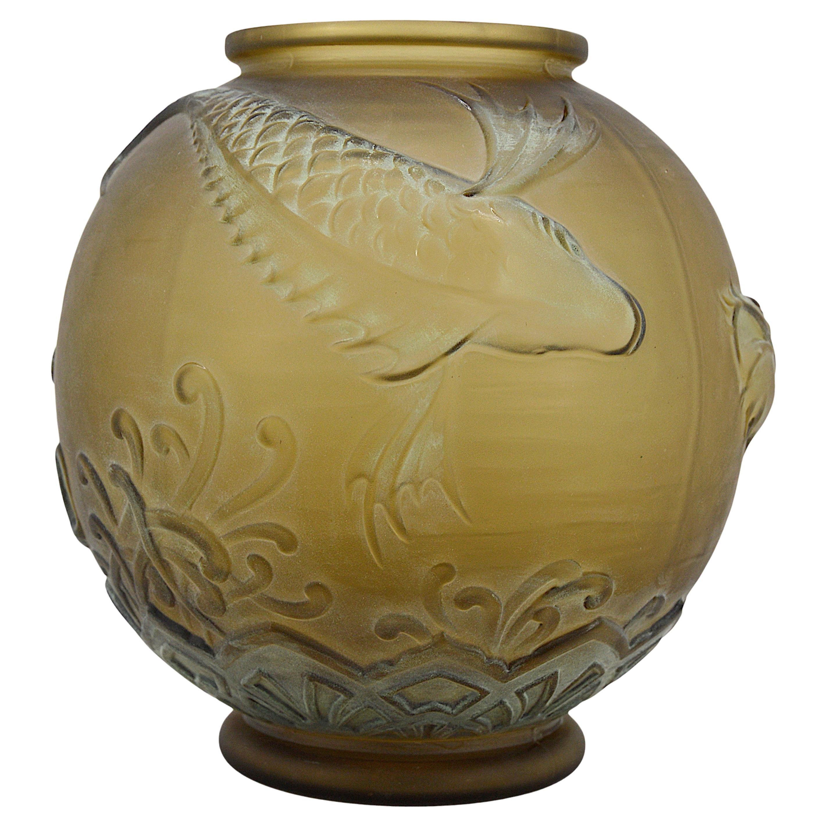 Large French Art Deco vase by Pierre D'Avesn at Daum's (Croismare, Nancy), France, early 1930s. Decor of three fishes swimming in the middle of algae. Thick molded-pressed satiny glass. Green patina in places to accentuate the reliefs. Color varies
