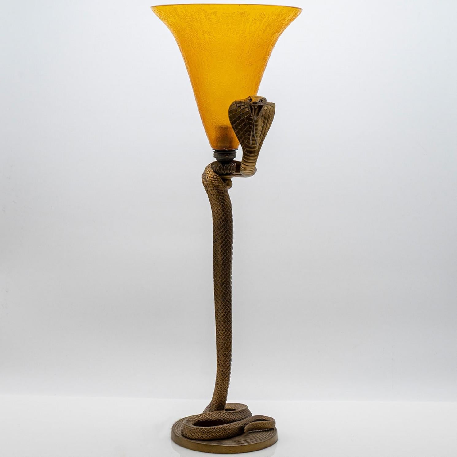 This beautiful table lamp is a real eye catcher. Made by Daum in Nancy, France.

A stunning table lamp, with a bronze snake and yellow crystal glass.

Daum is a renowned French glassmaker based in Nancy, in the Lorraine region. Founded in 1878 by