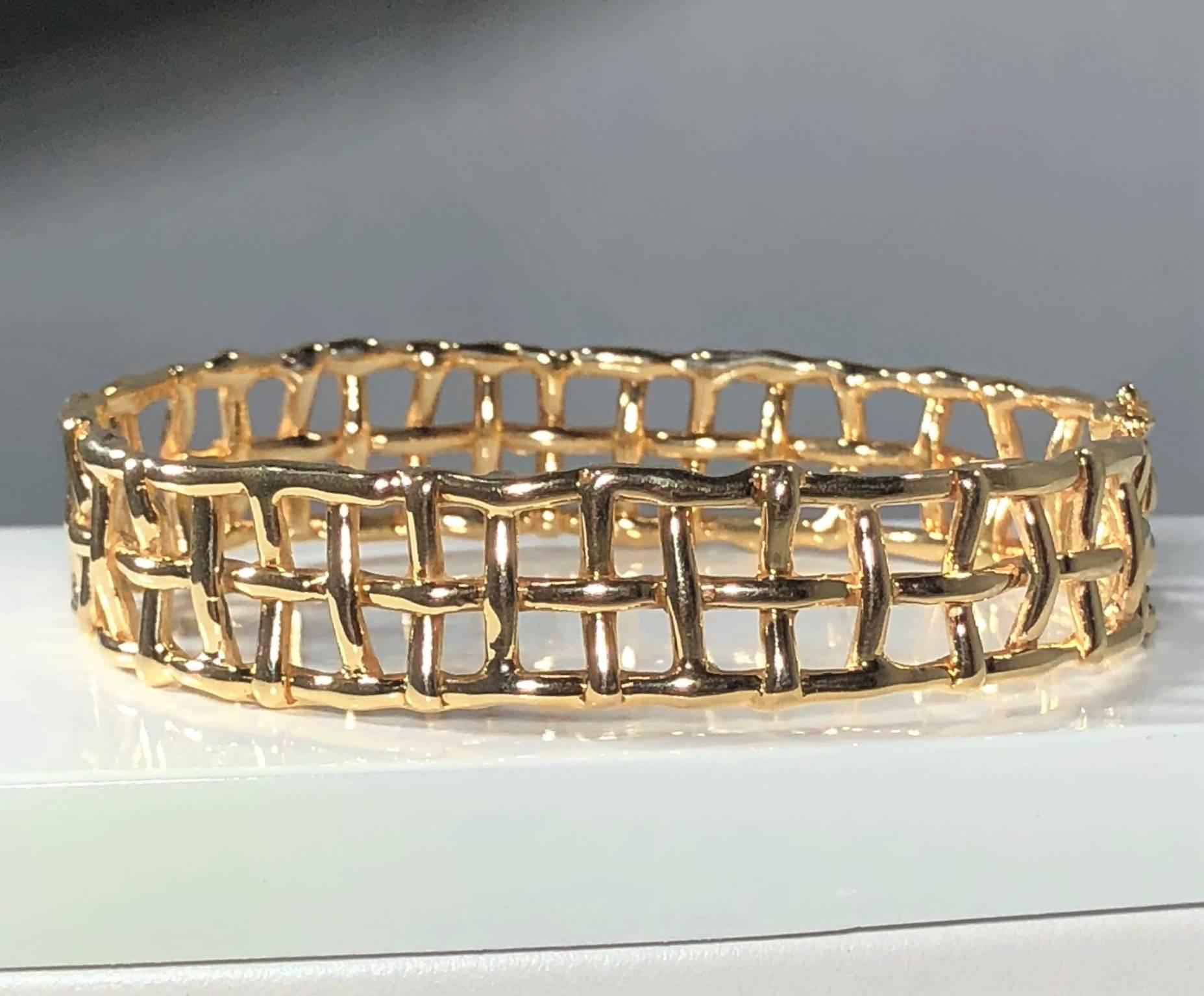 Daunis 14 karat yellow gold hinged cuff bracelet. This piece is a Daunis creation. Created in 14 karat yellow gold weighing 34.1 grams and 21.8 dwt. Gate/stake closure with safety clasp. Such a Modern twist on a classic staple piece. This cuff