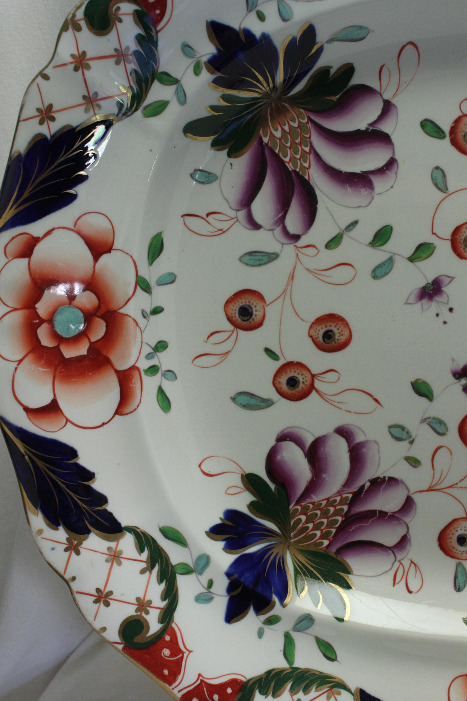 This Davenport platter is decorated with a hand coloured and gilded Imari pattern-Davenport's pattern number 76. The pattern features stylised flowers and berries done in the traditional Imari colours of underglaze blue, iron red and gilding, with