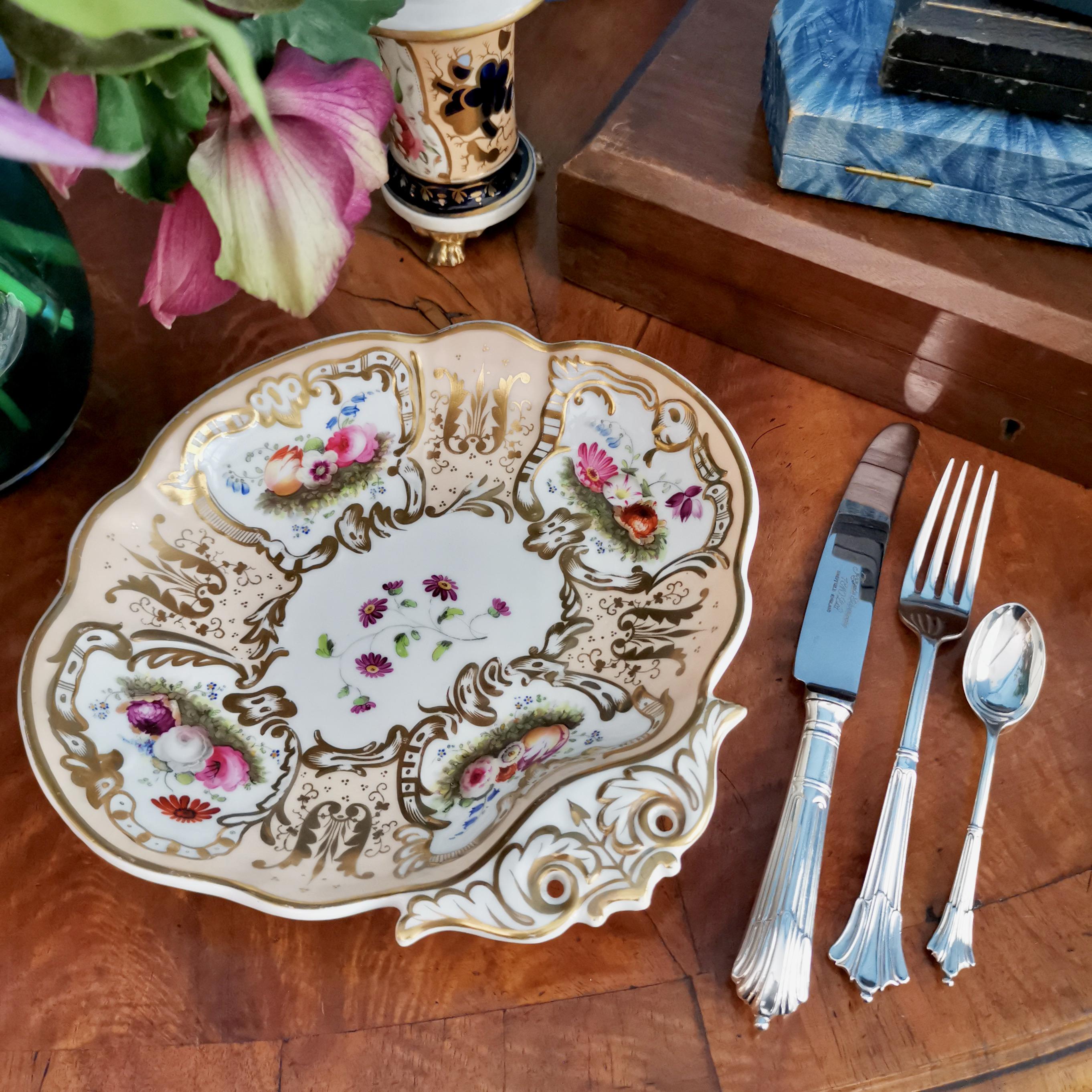 This is a beautiful dessert serving dish made by Davenport circa 1830. The dish is decorated in a beautiful salmon ground with gilt and hand painted flowers, and has a very characteristically moulded handle.

Davenport was one of the pioneers of