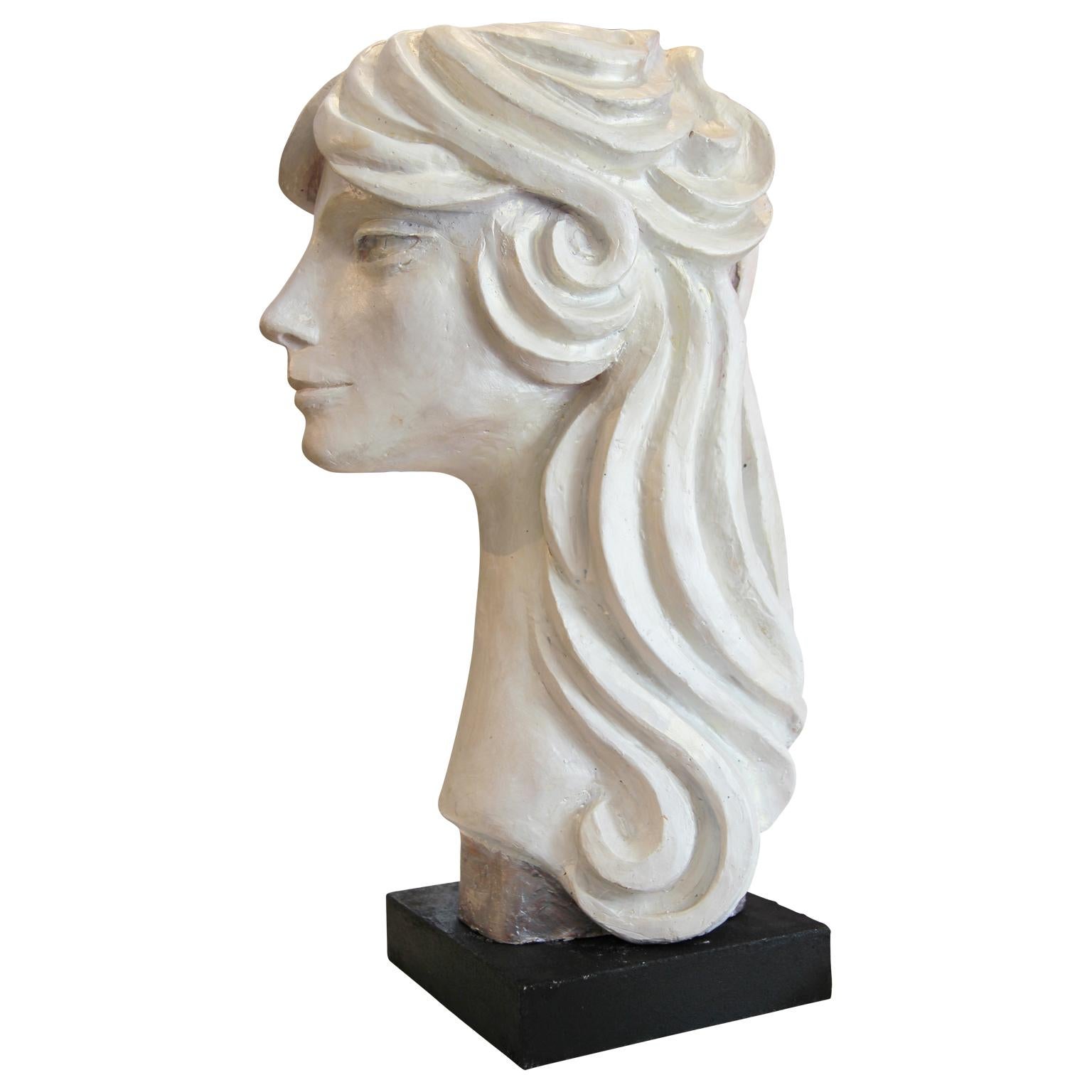 Modern abstract cast stone portrait bust sculpture by Houston, Texas artist David Adickes. The work is modeled after Adickes' friend Julie Burrows and features sharp facial features framed by swooping hair. Signed by artist on the back of the neck.