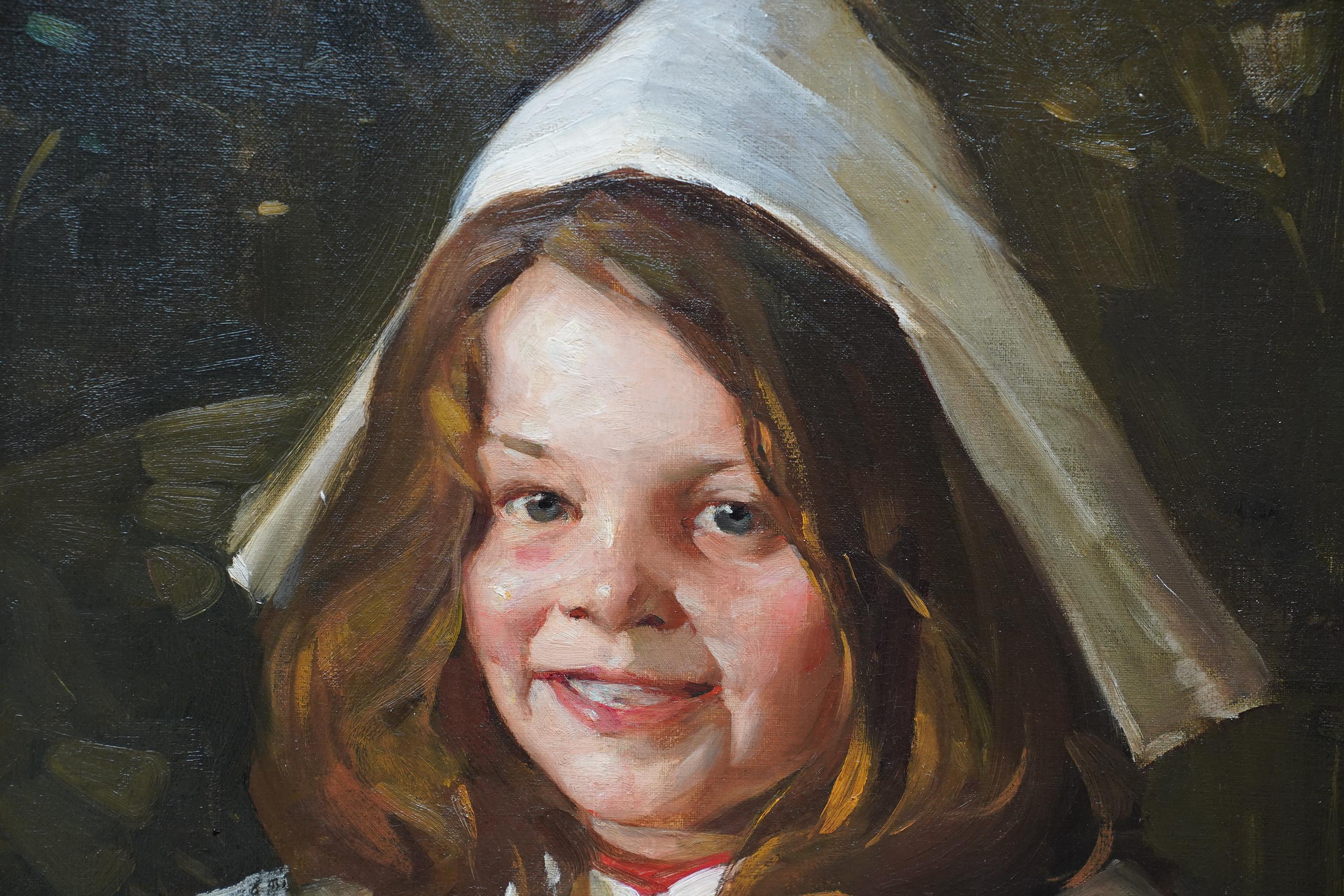 This cheery Scottish portrait oil painting is by noted artist David Alison. Painted in 1906 it is a half length portrait of a smiling girl in a red dress and white collar and white party hat against a dark patterned background. Her dark curling hair