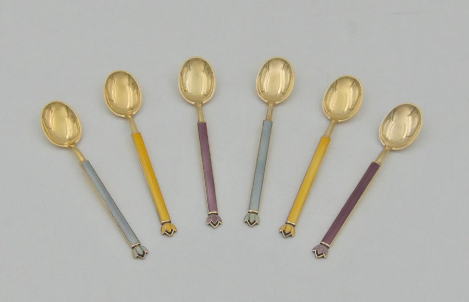 A vintage set of six sterling silver gilt and guilloche enamel spoons from Norwegian gold and silversmith firm, David Andersen, dating circa 1940s. The firm was founded 1876 in Christiania (now Oslo). Each solid silver spoon has a gold wash surface