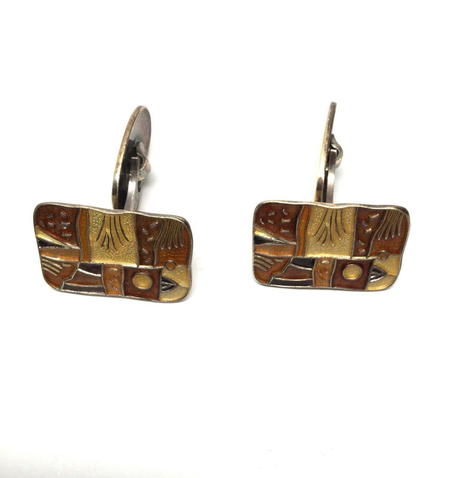 Vintage David Andersen Norway Sterling Silver Autumn Cufflinks with Enamel

These cufflink faces are rectangular with gold washed sterling silver outlining the edges. The enamel is in rich and powerful shades of brown and cream designed by David