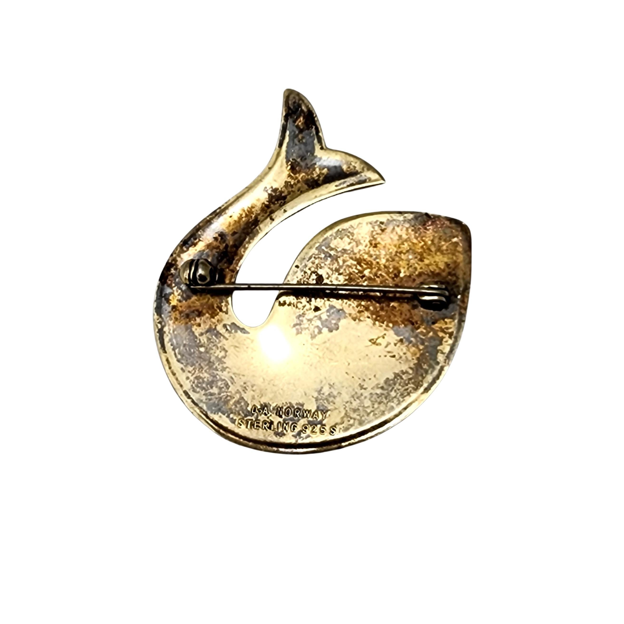 Vintage modernist sterling silver and enamel fish pin/brooch by David Andersen Norway.

This piece features beautiful enamel work with a gold vermeil over sterling silver in the shape of a splashing fish or whale.

Measures approx 1 3/4