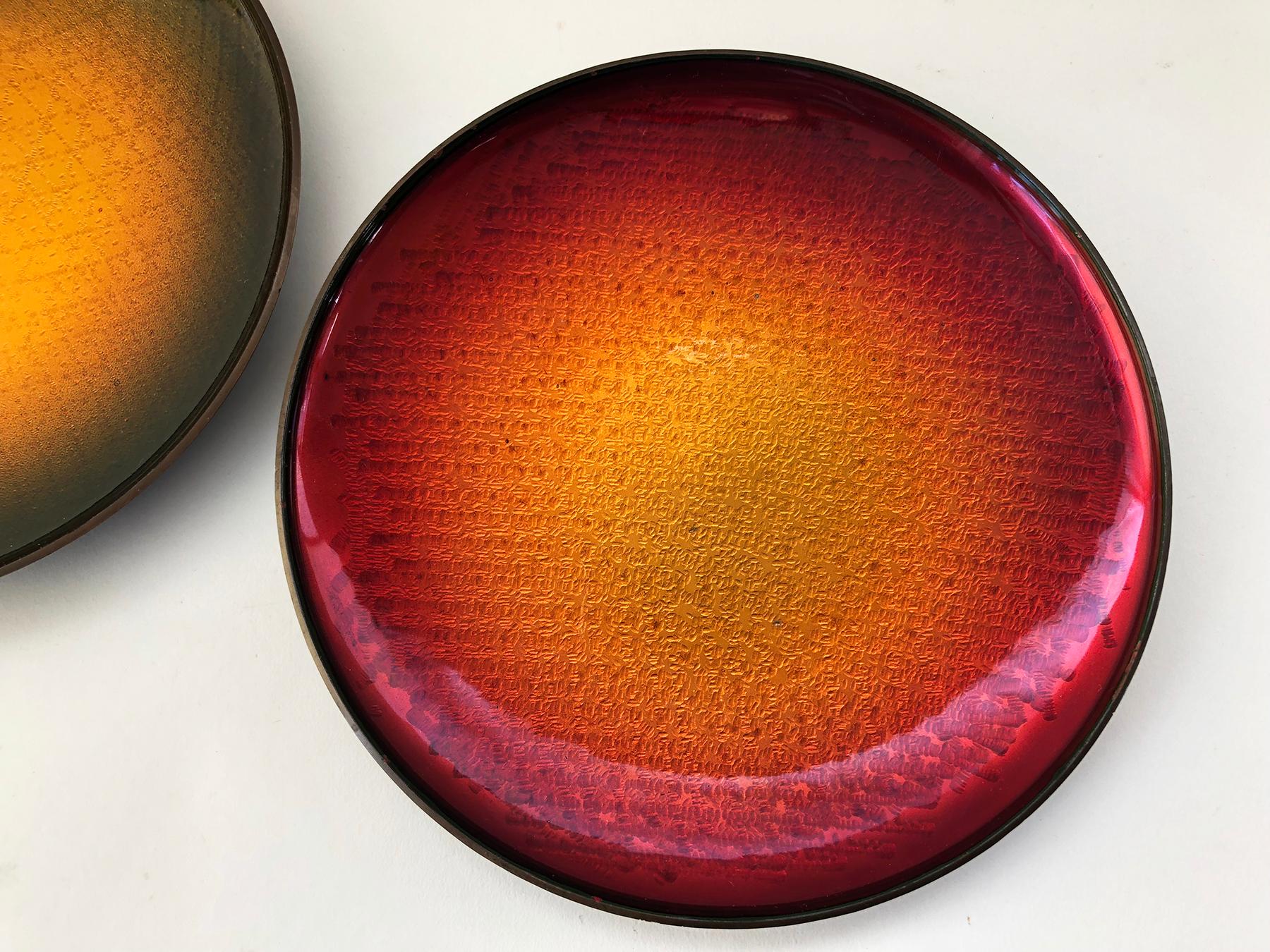 Pair of Norwegian enamel over copper trays or plates by David Andersen, circa 1960s. Plates have good weight and also have a hanging device on the bottom. Measuring 8.25