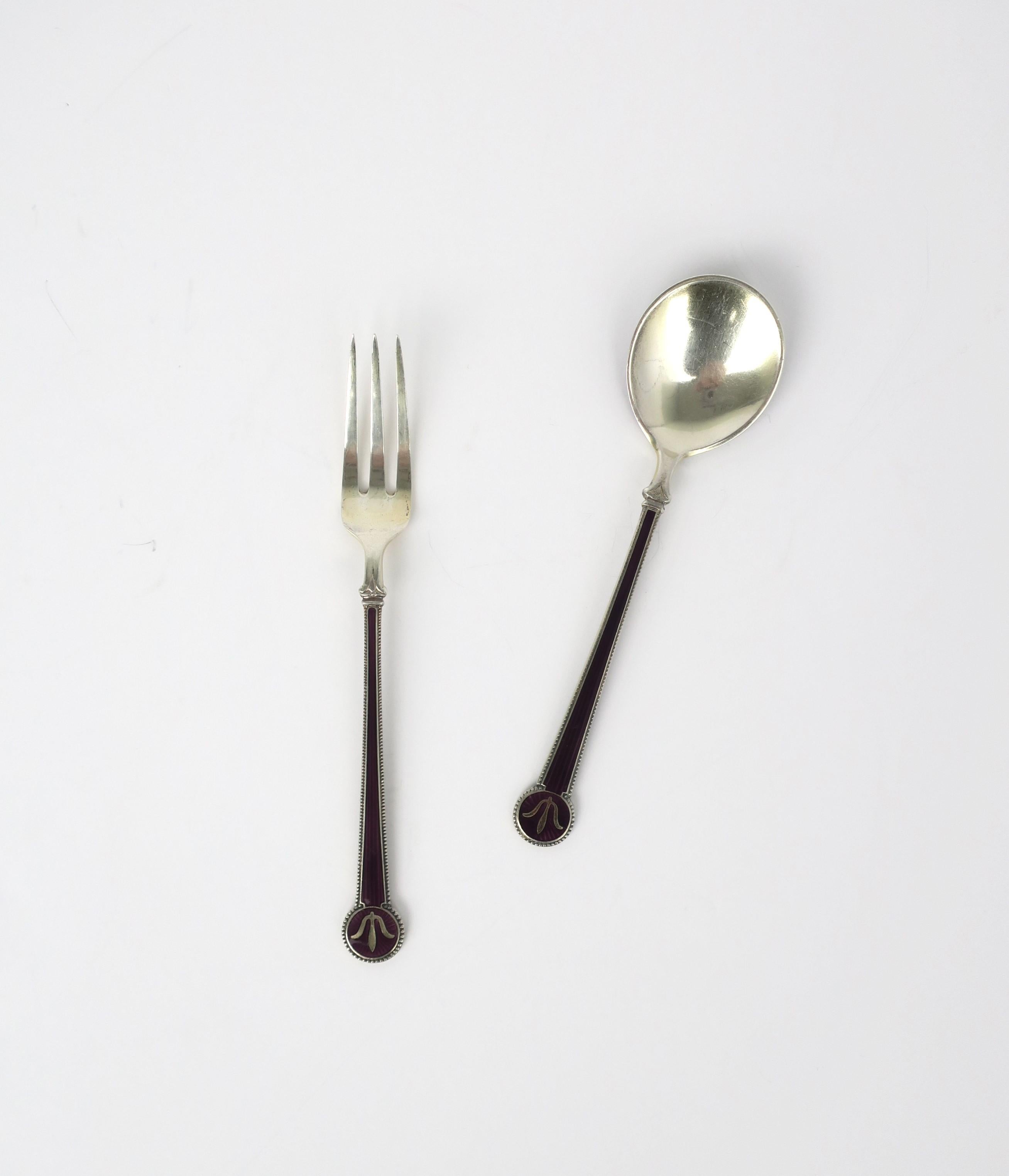 A beautiful and fine set of sterling silver and purple eggplant enamel guilloche appetizer fork and spoon from Norwegian designer and silversmith, David Andersen, circa early-20th century, Norway. The quality of the guilloche enamel and sterling