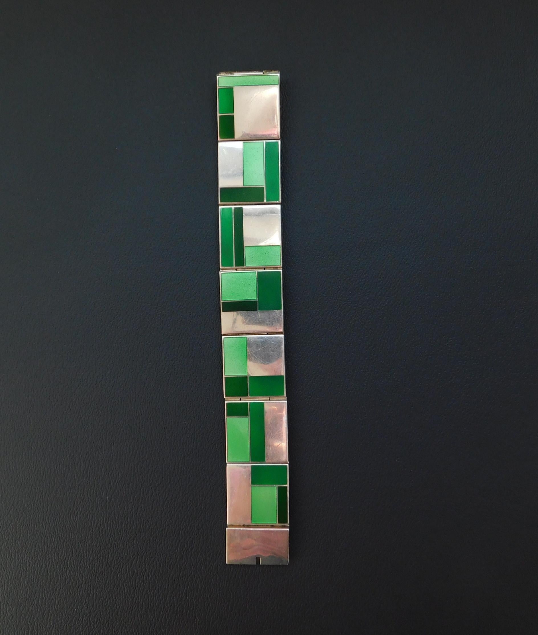 
Beautiful Modernist abstract panel link bracelet featuring green enamel 
and sterling geometric squares. It is a vintage bracelet in beautiful condition.
It has a sturdy working clasp. Designer is unknown.
It measures 1
