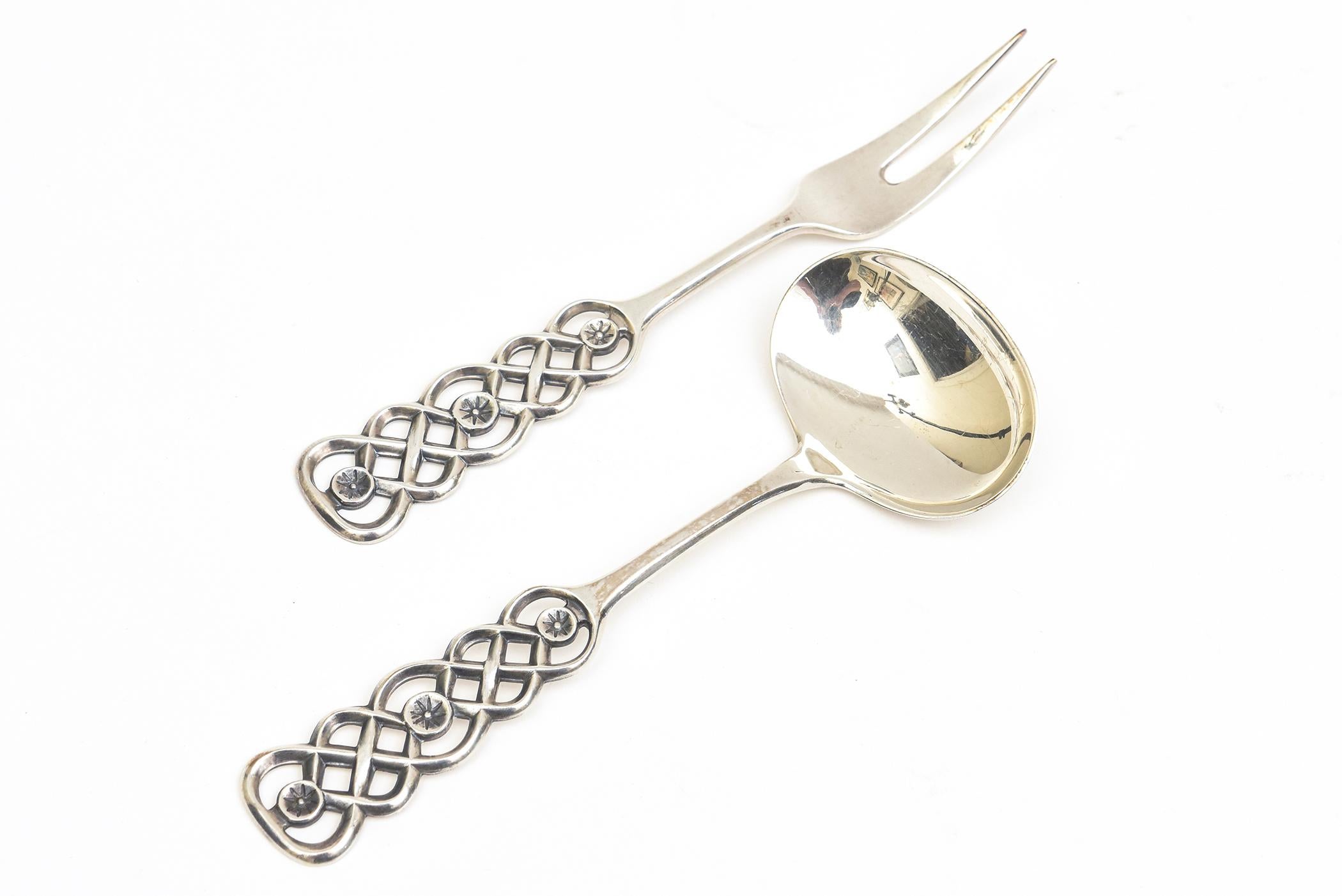 This sculptural set of 2 vintage sterling silver stunning serving pieces by the Norwegian artist David Anderson are early works of his and are for serving condiments. One is a pickle fork and the other a relish spoon. it is from the Ringbu pattern