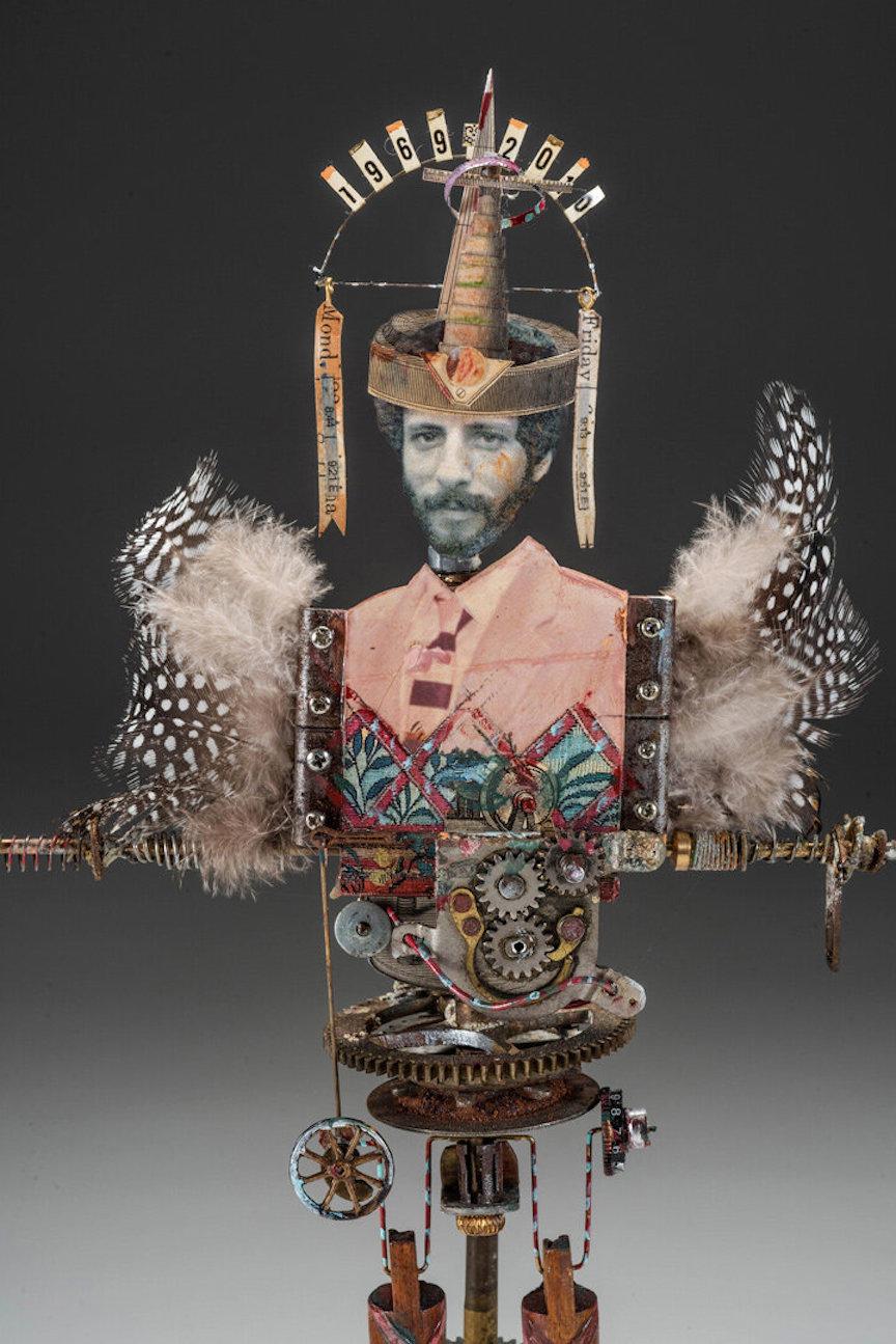 Barnett, a surrealist artist incorporates discarded mechanical objects and gadgets into his artwork. His work is characterized by its unique and eclectic mix of materials, which range from bottle caps, feathers, x-rays, machine parts, maps, doll