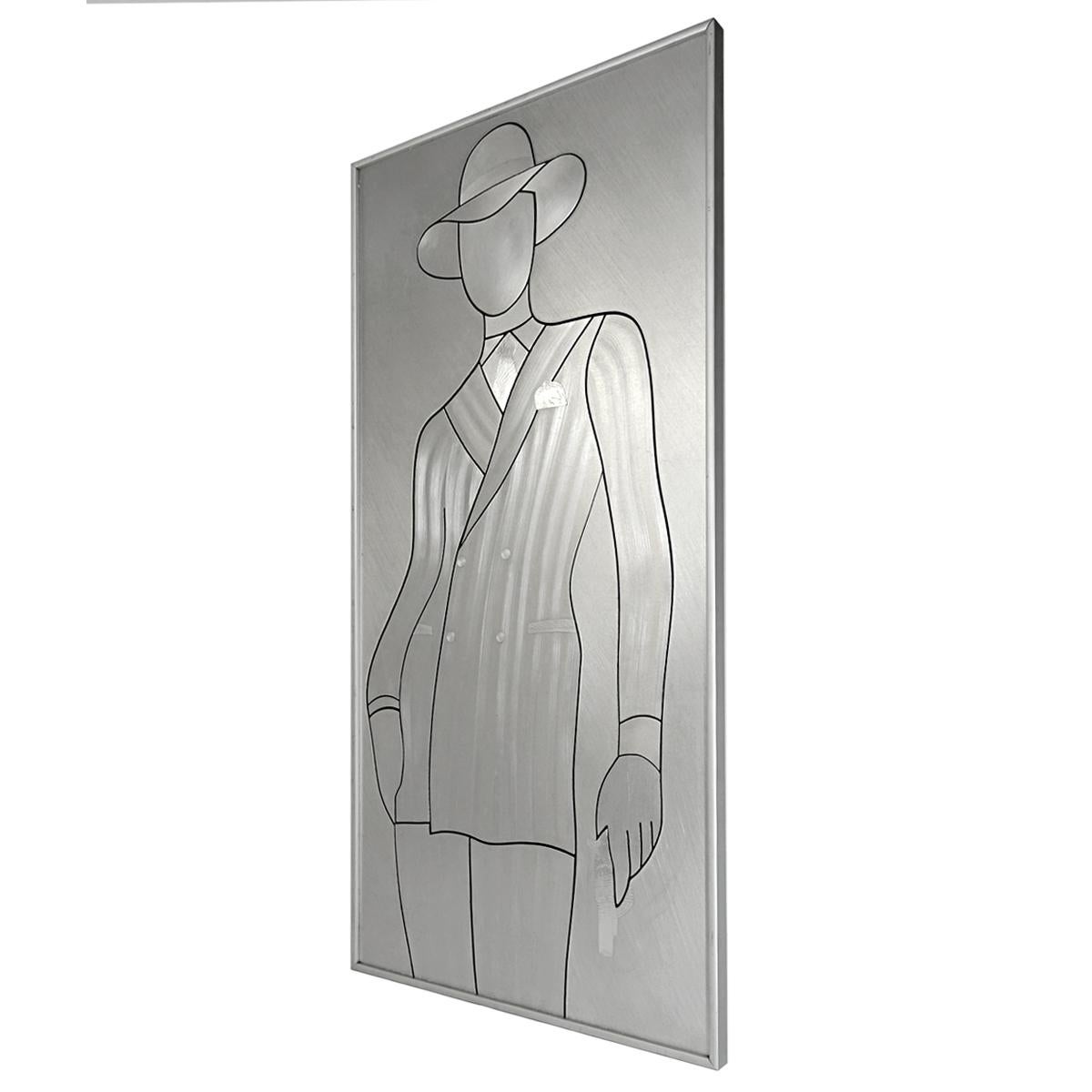 A stylized David Bowie in a piece of aluminum. His contours were created by cutting out his Silhouette in the material. Further details such as David’s hat, tie and jacket were brushed to distinguish themselves from the rest. His pochet and pocket