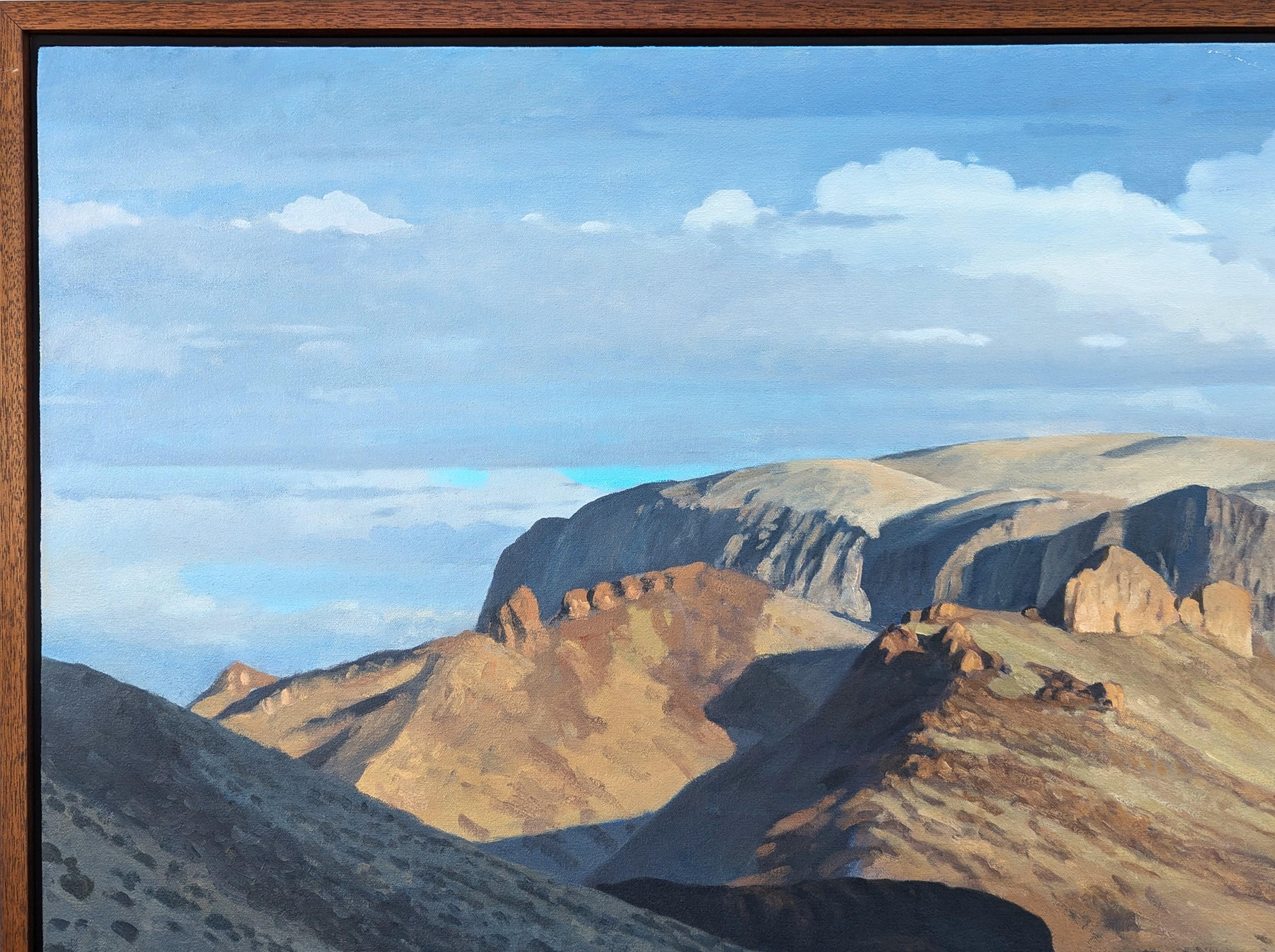Realistic pastel toned desert mountain landscape painting by Texas artist David Caton. The work features a rolling mountain range with desert brush and grass in the foreground. Signed in the front lower right corner. Currently hung in a floating