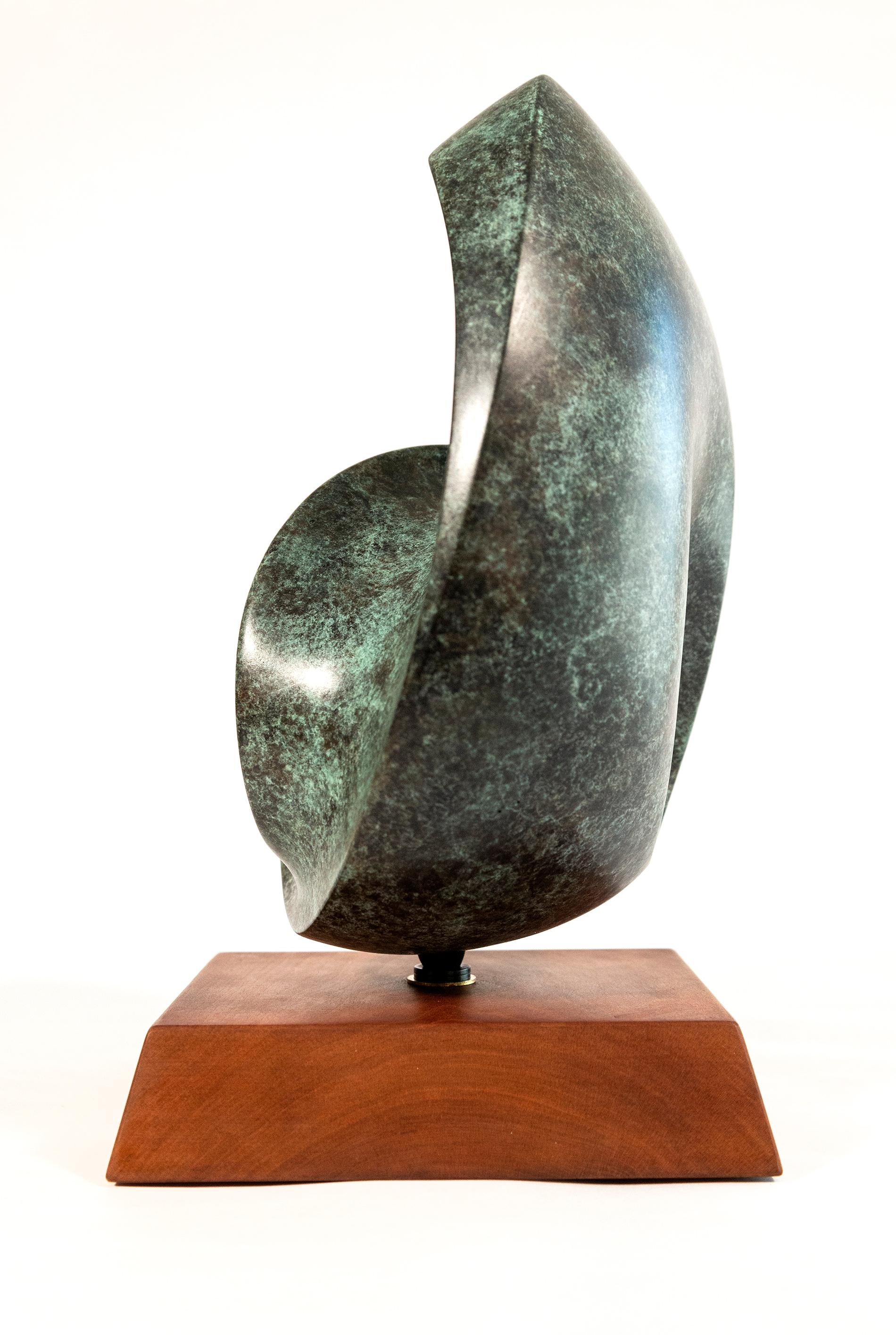 At once expressive and elegant, this abstract bronze sculpture is by David Chamberlain. The contemporary form is reminiscent of a half-moon shape and appears to be one continuous surface. Chamberlain’s sculptures are distinguished by this continuity