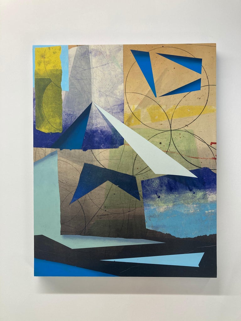 In this vertical, abstract painting in acrylic on paper on linen mounted on panel by David Collins geometric shapes in shades of dark indigo, navy and light sky blue, soft sage green, and bright yellow are colorful and vibrant. The angles and soft