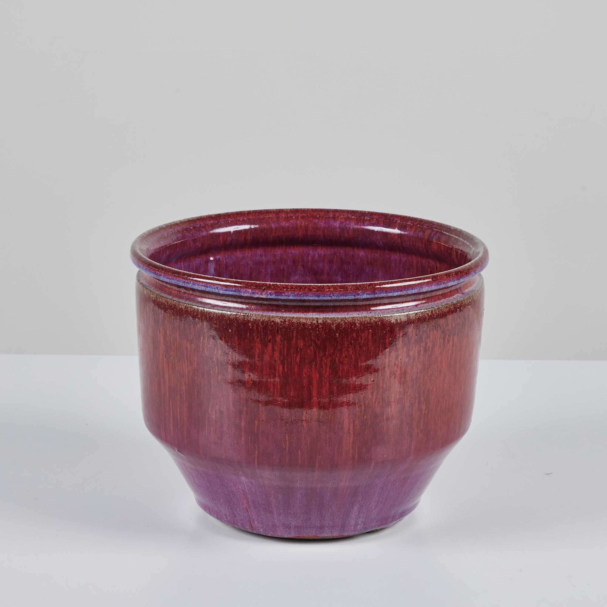 Ceramic bowl planter from David Cressey and Robert Maxwell for Earthgender. The table top sized planter has an ombre glazed interior and exterior ranging in colors of purple, pink and blue with slightly bowed sides and a flattened lip.
