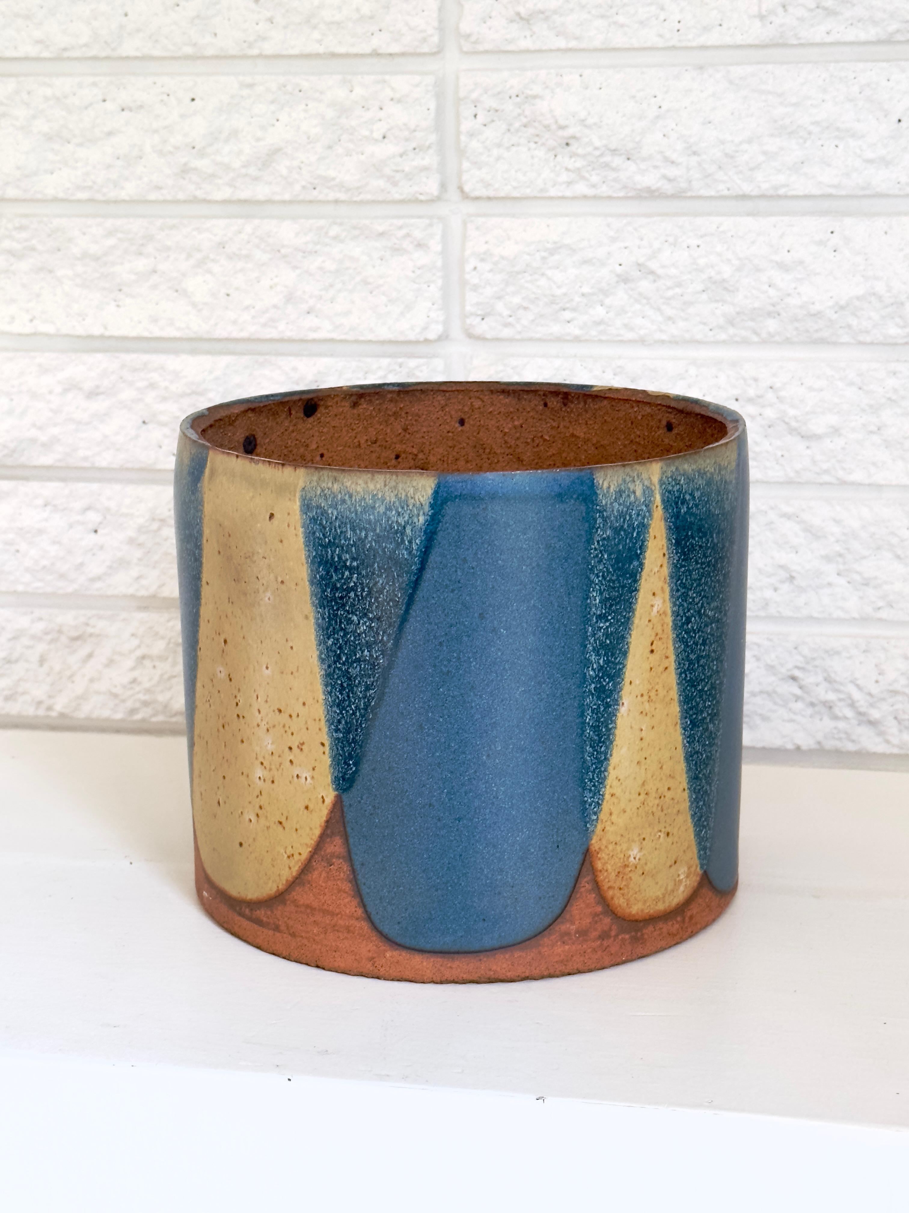 David Cressey Architectural Pottery Pro Artisan series flame glaze stoneware planter

Cylindrical form with flame glaze pattern in rarely seen Stone Blue and Sienna Yellow glaze combination
Great versatile size suitable for floor or surface