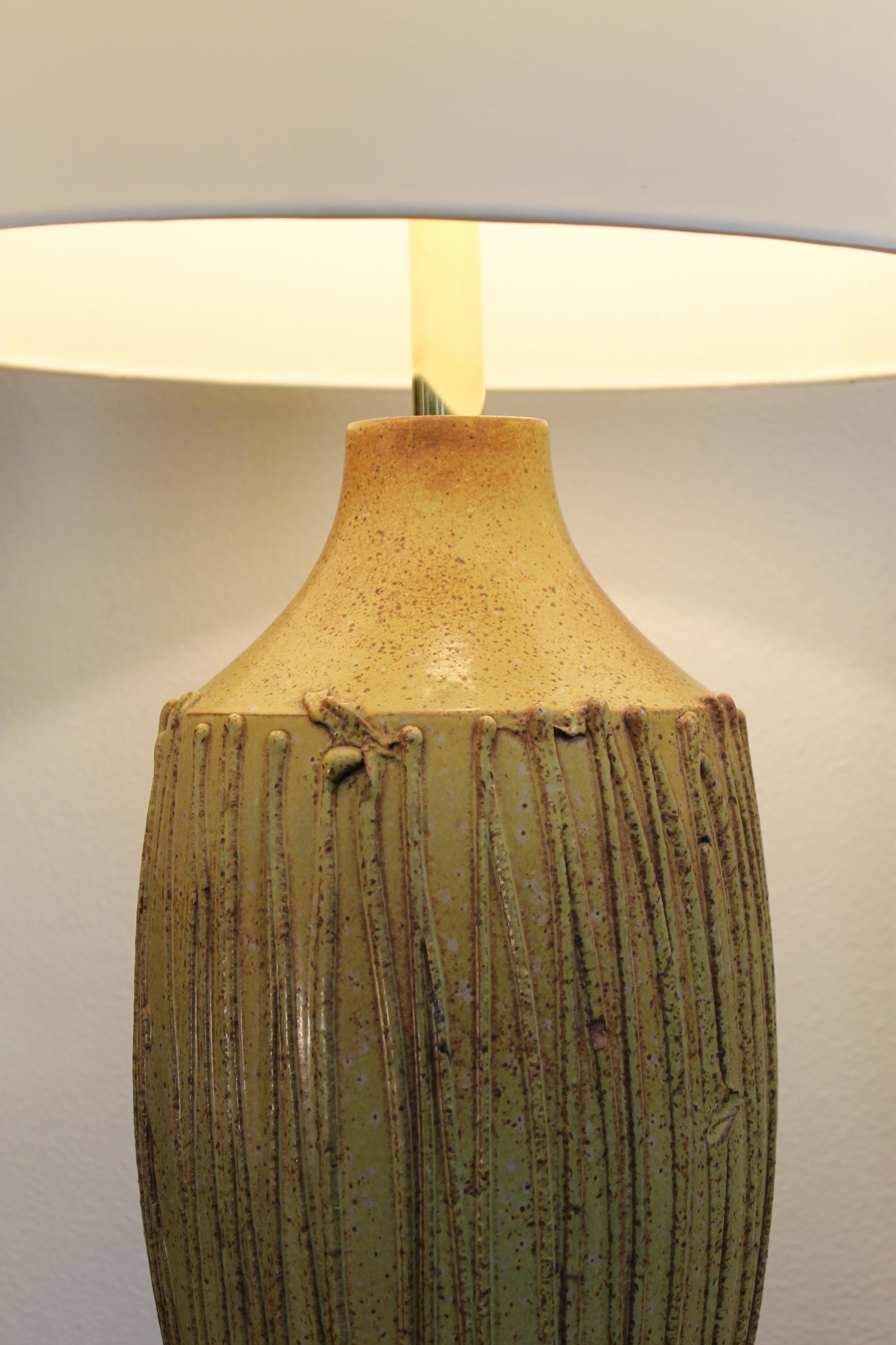 Pottery lamp by David Cressey in a mustard, brown color. Lamp measures 21