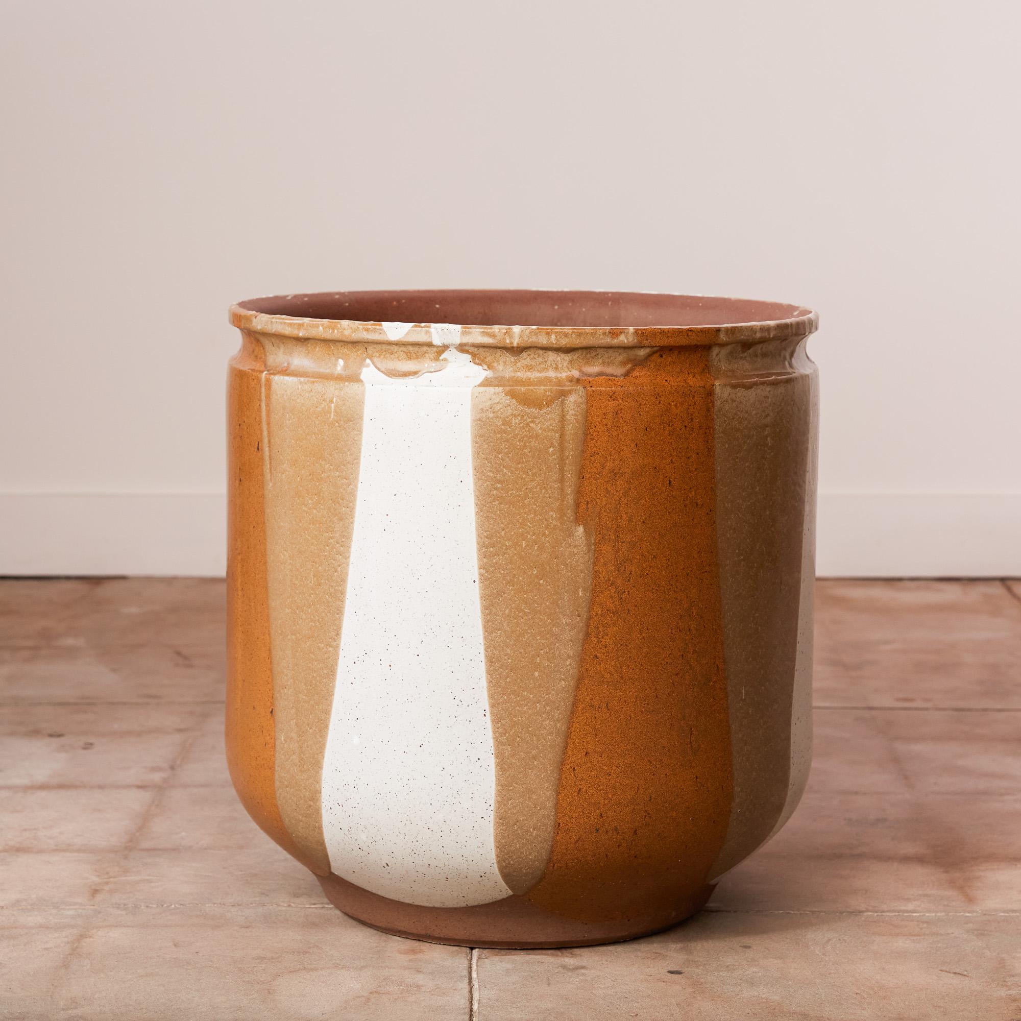 A tulip-shaped planter by David Cressey for the Pro/Artisan collection by Architectural Pottery with Cressey’s signature “Flame Glaze.” This planter has a rounded bottom with a flat foot and rounded lip at the opening, a simple shape rendered