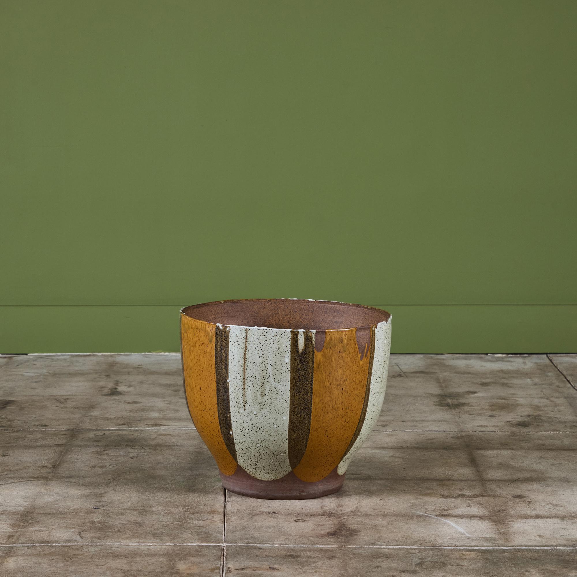 A bell-shaped planter by David Cressey for the Pro/Artisan collection by Architectural Pottery with Cressey’s signature “Flame Glaze.” This planter has a wide round opening, wide set at its middle section that tapers towards the bottom. A simple