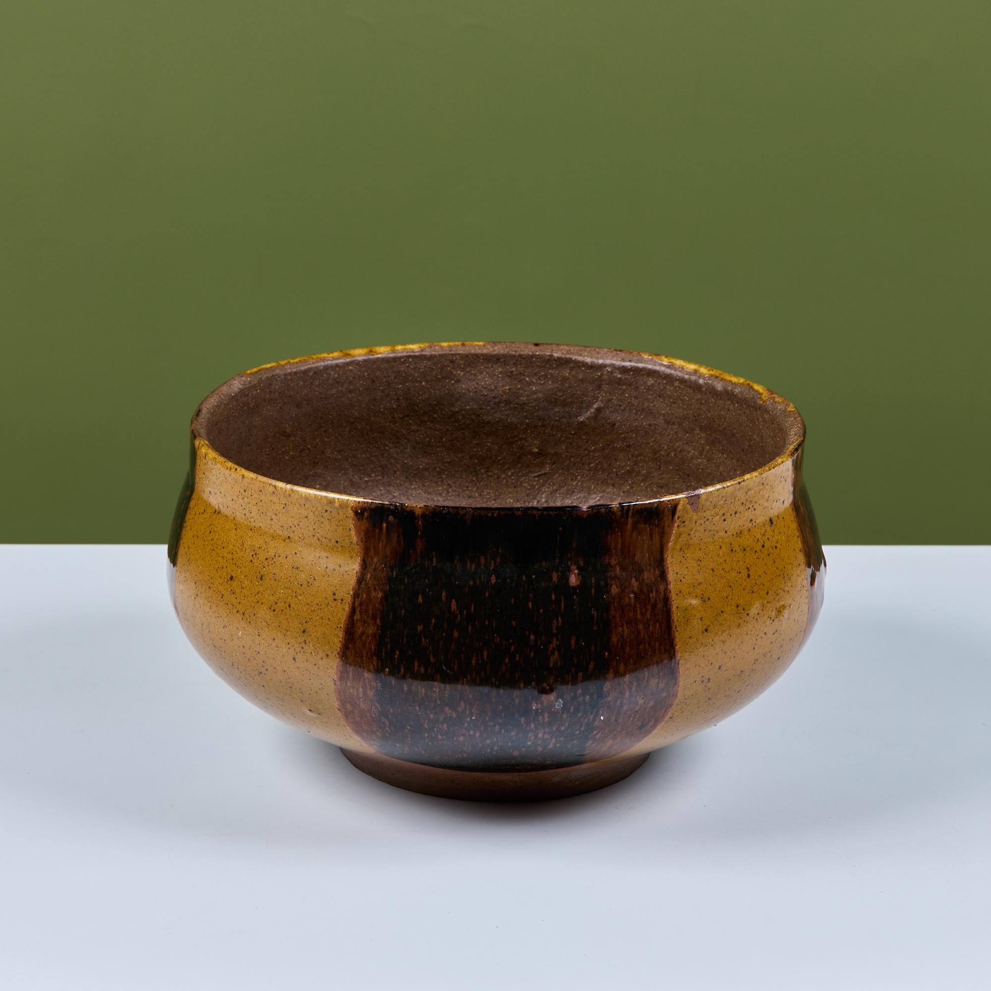 Planter by David Cressey for the Pro/Artisan collection by Architectural Pottery with Cressey’s signature “Flame Glaze.”  This planter has a flat lipped rim and wide belly that tappers towards the bottom. A simple shape rendered dramatic by the