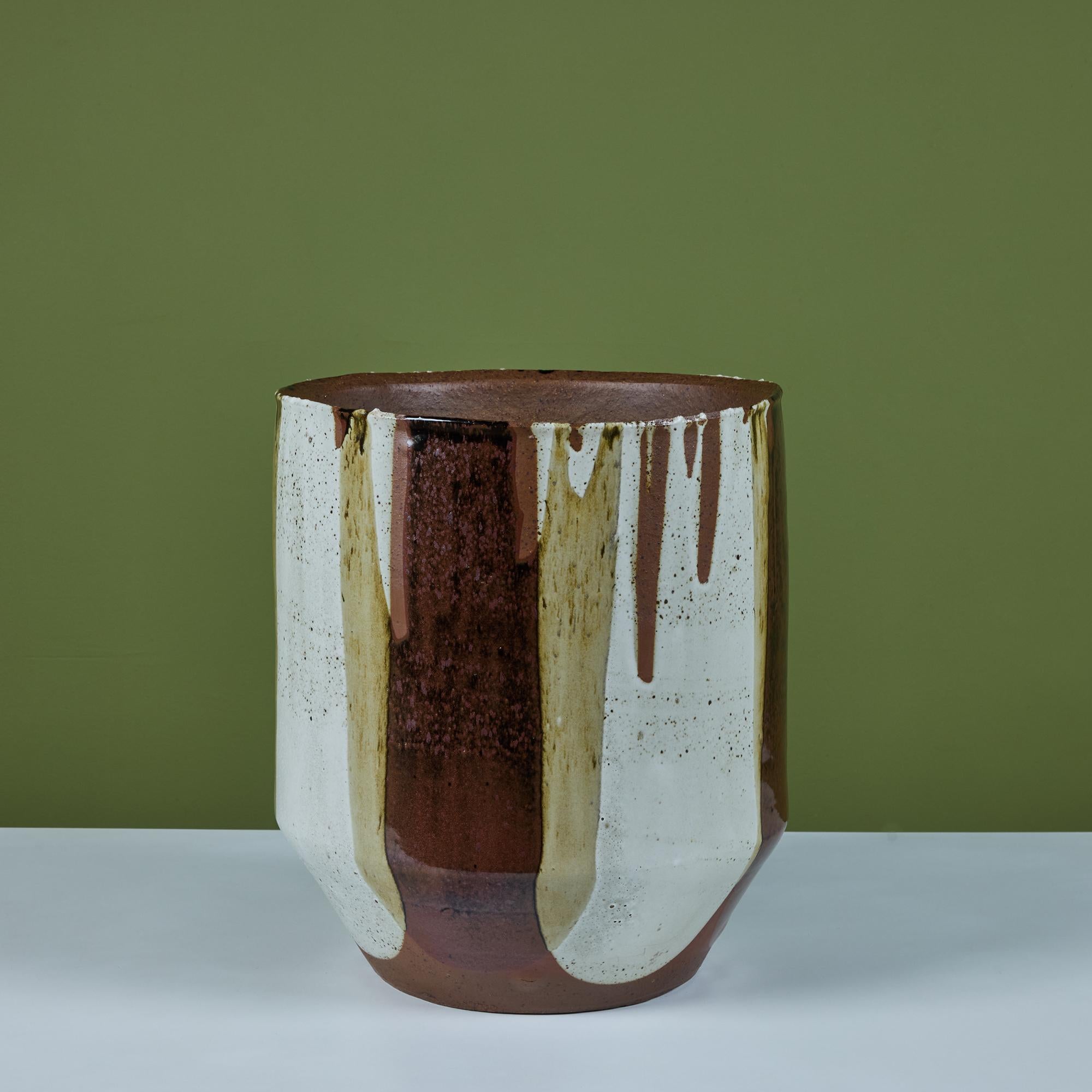 John Follis Bullet planter with David Cressey's signature “Flame Glaze” for the Pro/Artisan collection by Architectural Pottery. The planter has slightly bowed sides and a flattened lip while the bottom tappers inwards. The simple shape rendered
