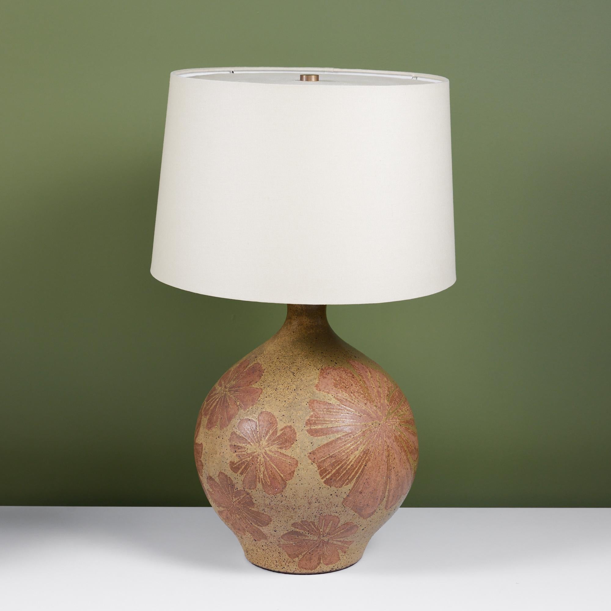 Large scale David Cressey Ceramic Lamp, c.1960s, USA. The wheel thrown ceramic lamp features a speckled greenish colored glaze with applied floral detailing in a brown-red tone. The newly rewired lamp features a new linen shade. The shade and