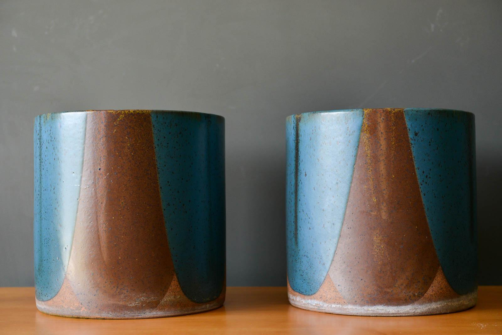 Pair of David Cressey for Architectural Pottery Pro/Artisan blue flame glaze planters, ca. 1970. Highly desirable blue/brown/ochre speckle interior planters in Cressey's signature poured flame glaze technique. Both are in excellent original