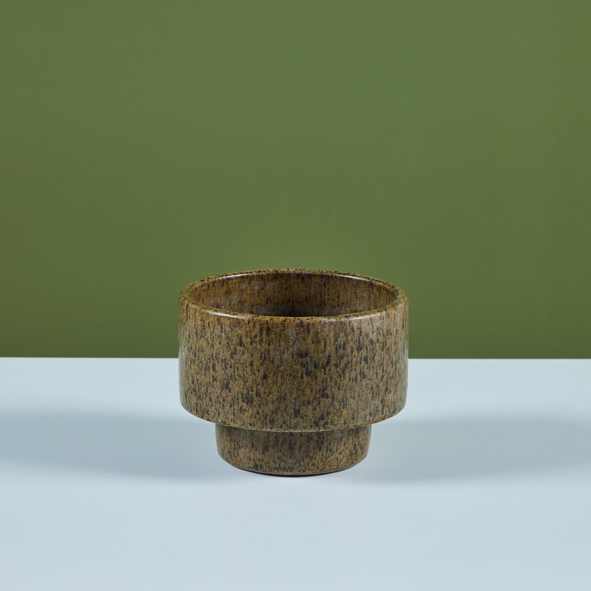 David Cressey Pro/Artisan collection planter for Architectural Pottery. This stoneware planter has a speckle glazed interior and exterior in light olive. The petite table planter has large cylindrical body and tapers to a slightly smaller