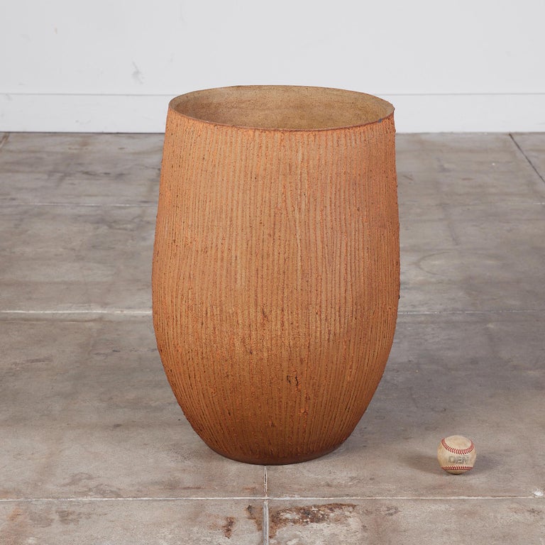 Cigar planter by David Cressey from the Pro/Artisan collection for Architectural Pottery. This stoneware planter has an unglazed interior as well as an unglazed natural warm brown clay exterior with the iconic 