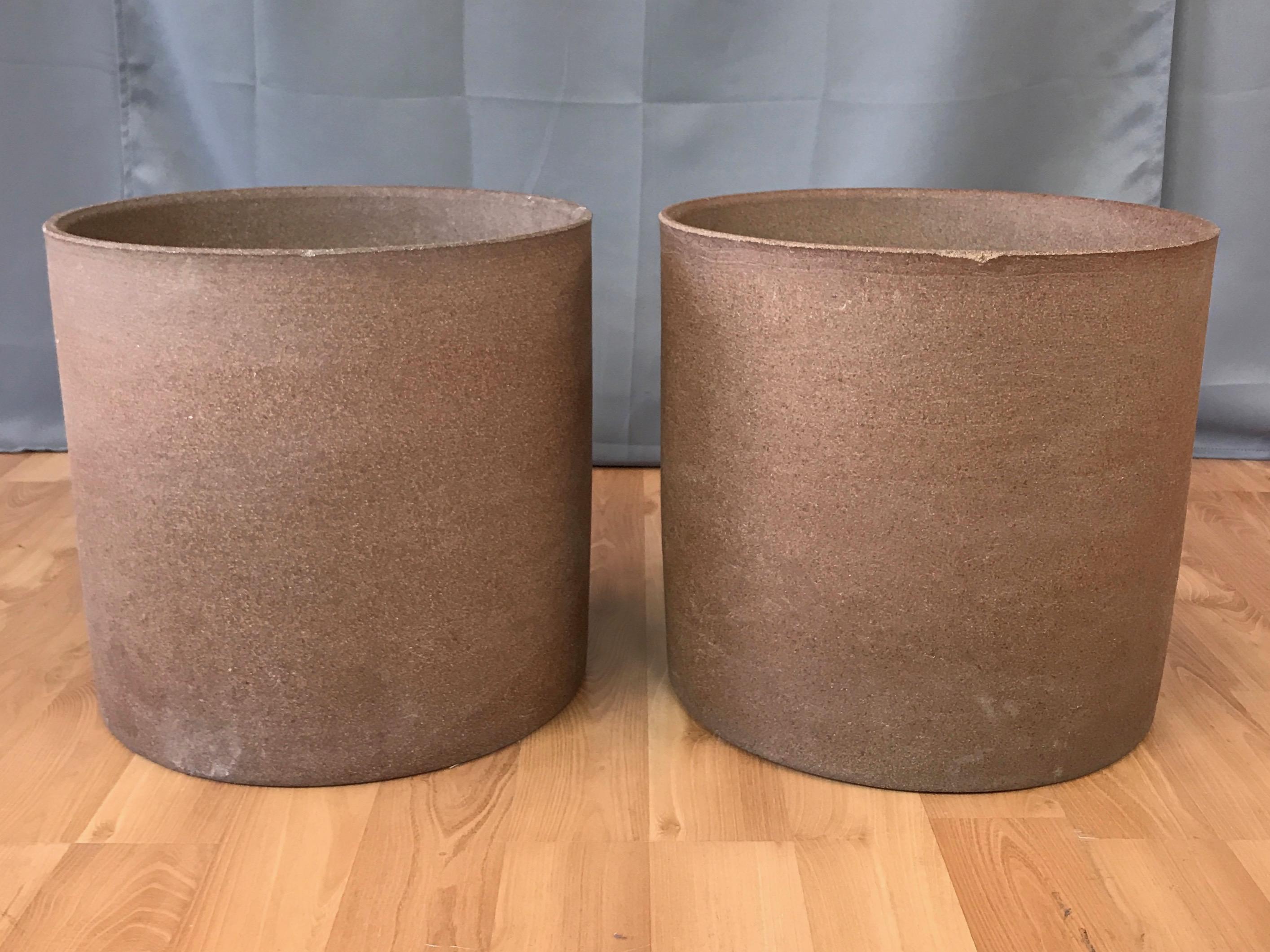 Large cylindrical unglazed stoneware planters by David Cressey from his 1960s Pro/Artisan collection for Architectural Pottery, offered individually.

Minimalist straight-sided form resembles an oversized earthen core sample, allowing one to imagine