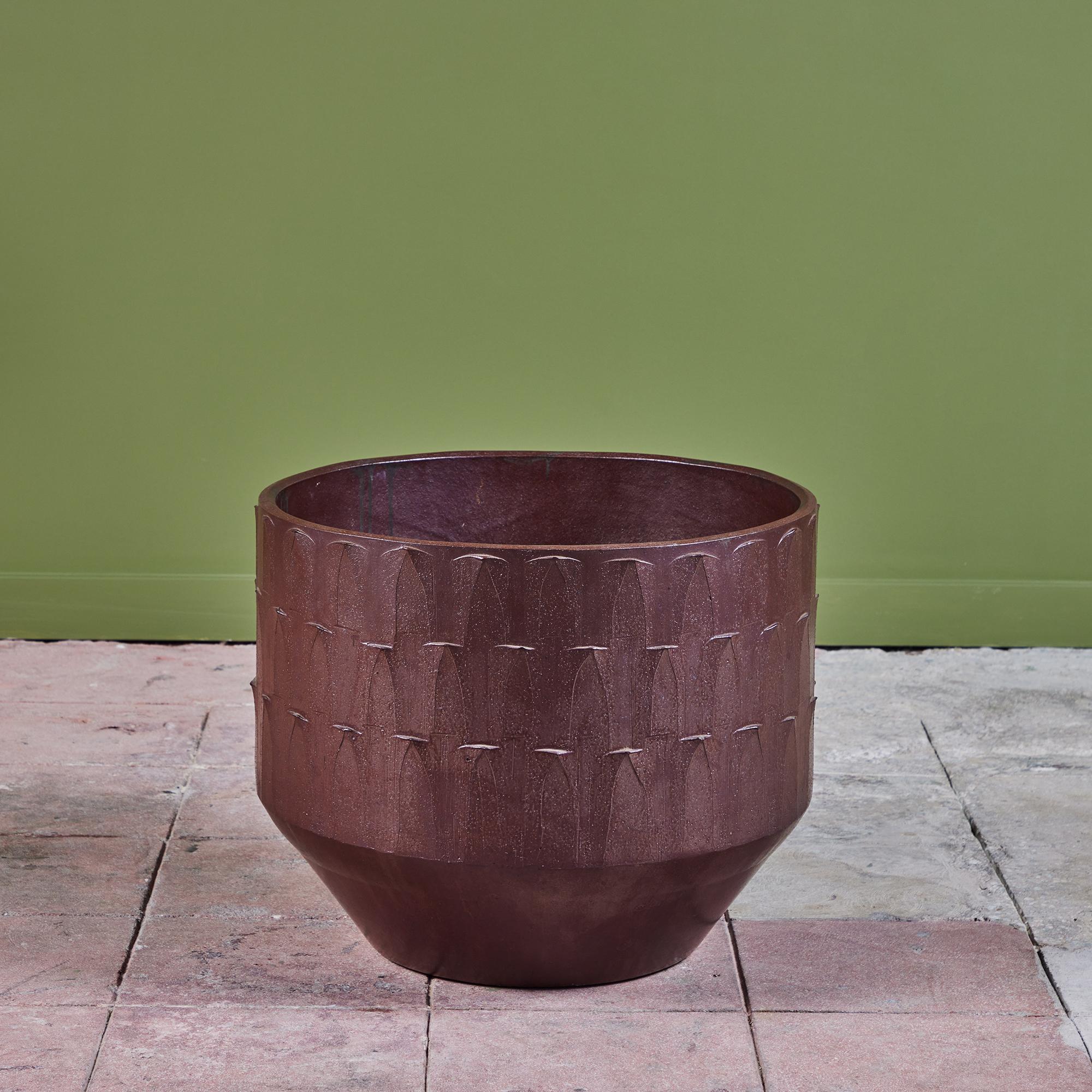 Bullet planter by David Cressey from the Pro/Artisan collection for Architectural Pottery. This planter has a soft speckled glaze in plum on both the interior and exterior. The exterior of the planter is finished with the “ribbed”