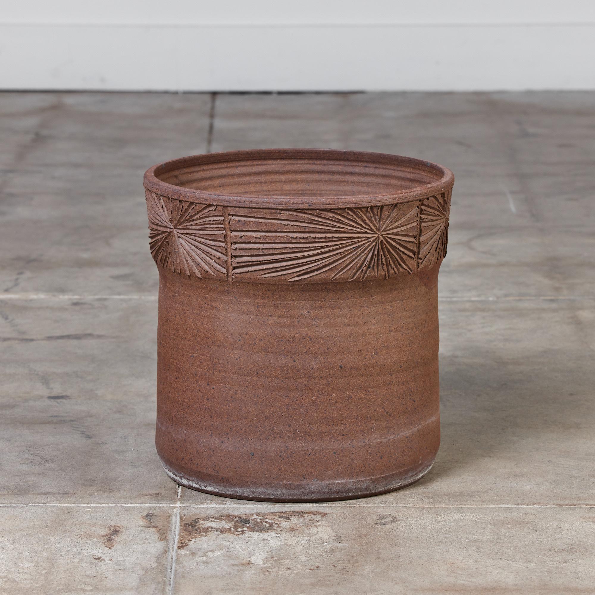 This stoneware planter, c.1970s, USA, is a result of the collaboration between David Cressey & Robert Maxwell to create the line Earthgender. This hand thrown planter features a hand incised four inch 