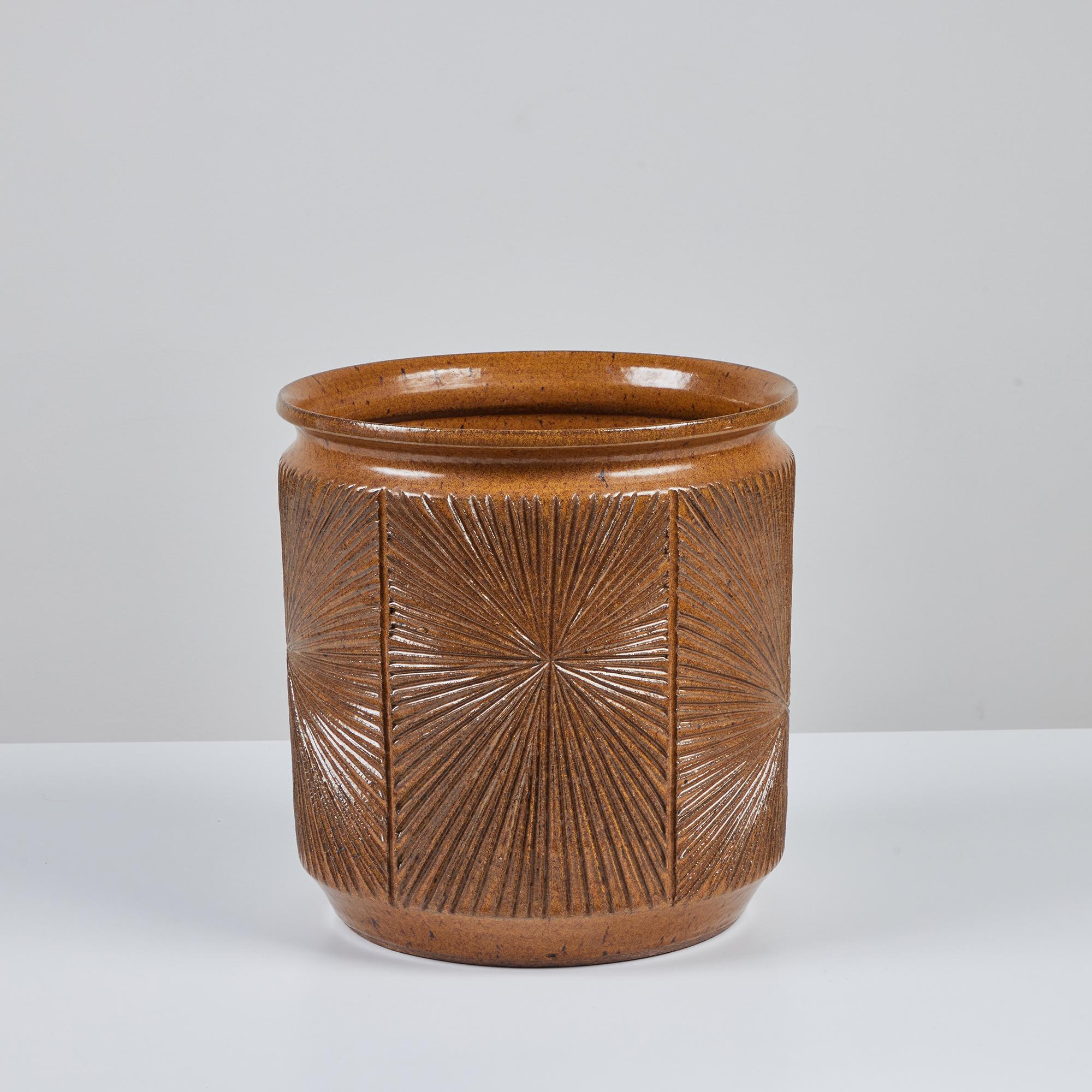 Hand thrown stoneware planter from Earthgender, David Cressey and Robert Maxwell’s early 1970s project. This 13.5” diameter example is incised in the “Sunburst” design a pattern of lines radiating from a central point. The exterior and interior of
