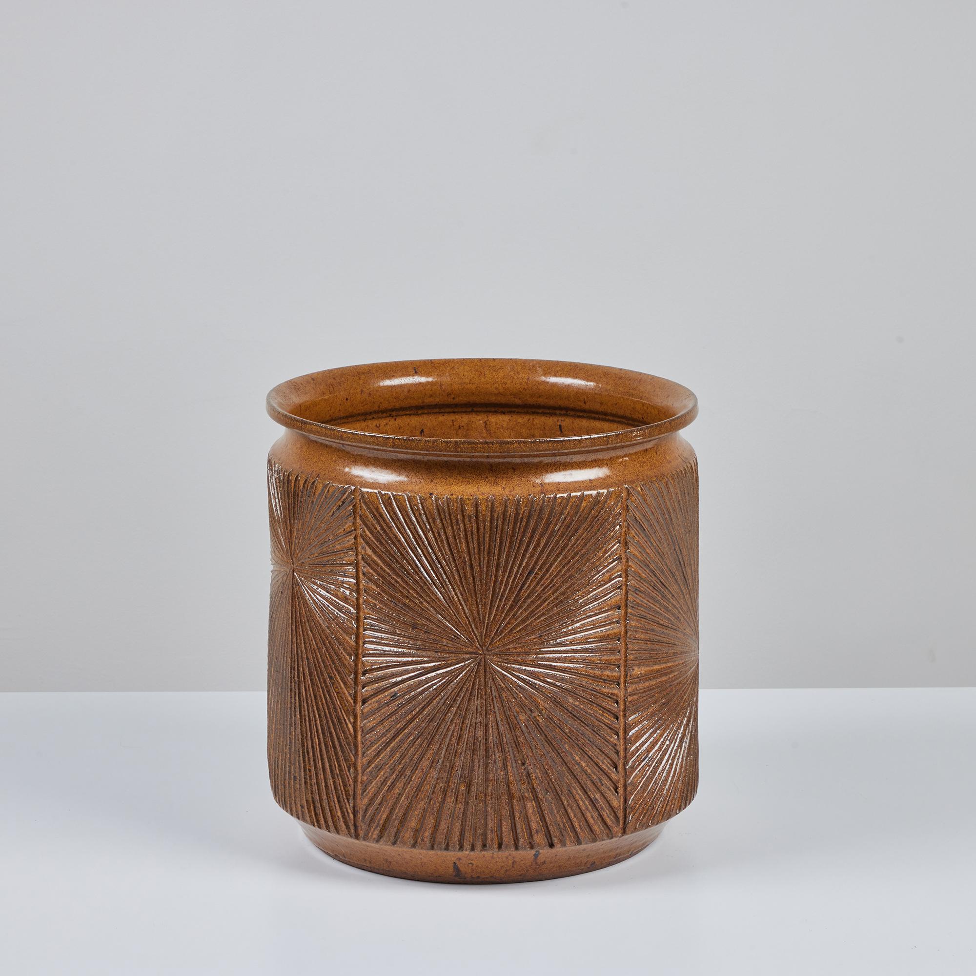 Hand thrown stoneware planter from Earthgender, David Cressey and Robert Maxwell’s early 1970s project. This 13” diameter example is incised in the “Sunburst” design a pattern of lines radiating from a central point. The exterior and interior of the