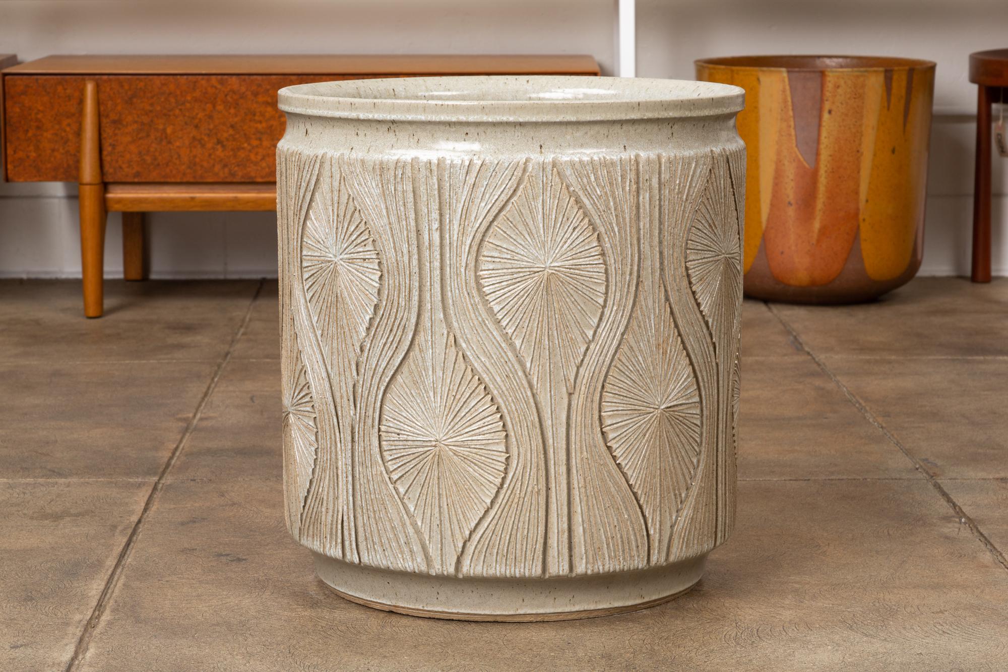 A cylindrical planter from Earthgender, David Cressey and Robert Maxwell’s early 1970s project. This 17.5” diameter example is incised in the “Teardrop Sunburst” design with interlocking gestural curves separating a pattern of lines radiating from a