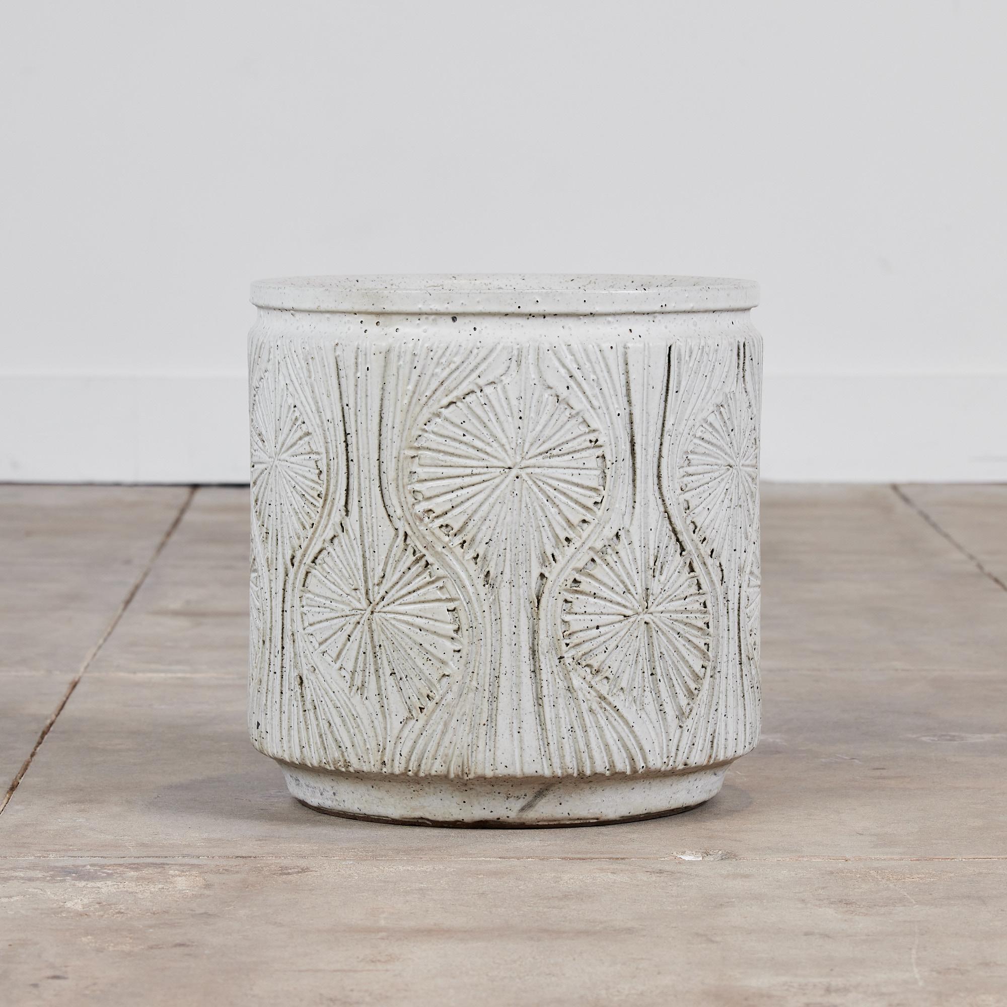 A cylindrical planter from Earthgender, David Cressey and Robert Maxwell’s early 1970s project. This 14.75” diameter example is incised in the “Teardrop Sunburst” design with interlocking gestural curves separating a pattern of lines radiating from