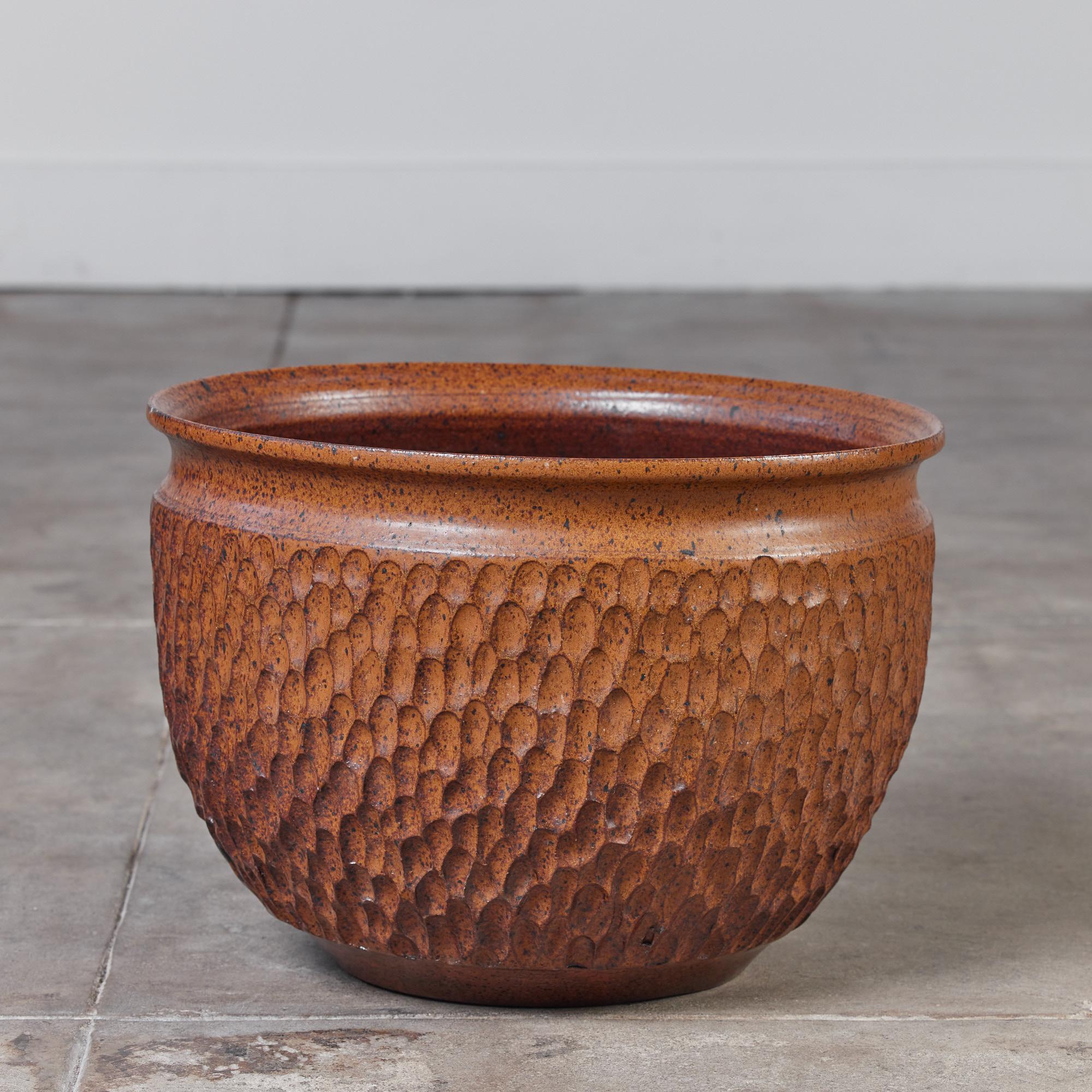 A wide stoneware planter from Robert Maxwell and David Cressey’s 1970s collaboration, Earthgender. One of the less common designs from this partnership, the ‘thumbprint’ pattern has a textured surface of repeating impressed concavities. This example