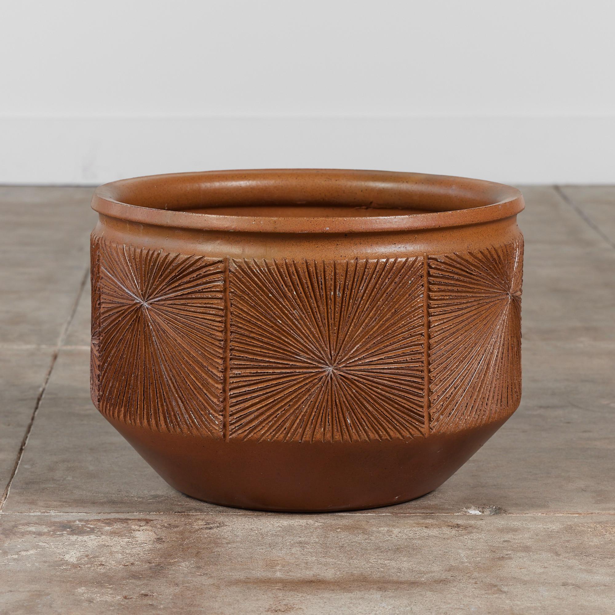 Hand thrown stoneware planter from Earthgender, David Cressey and Robert Maxwell’s early 1970s project. This 18” diameter example is incised in the “Sunburst” design a pattern of lines radiating from a central point. The interior and exterior of the