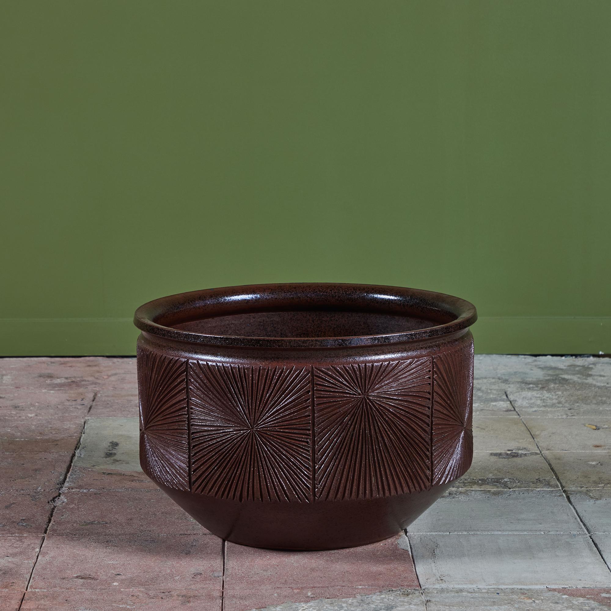Bowl planter from Earthgender, David Cressey and Robert Maxwell’s early 1970s project. This 23” diameter example is incised in the “Sunburst” design of lines radiating from a central point. The planter has an allover rich plum speckle