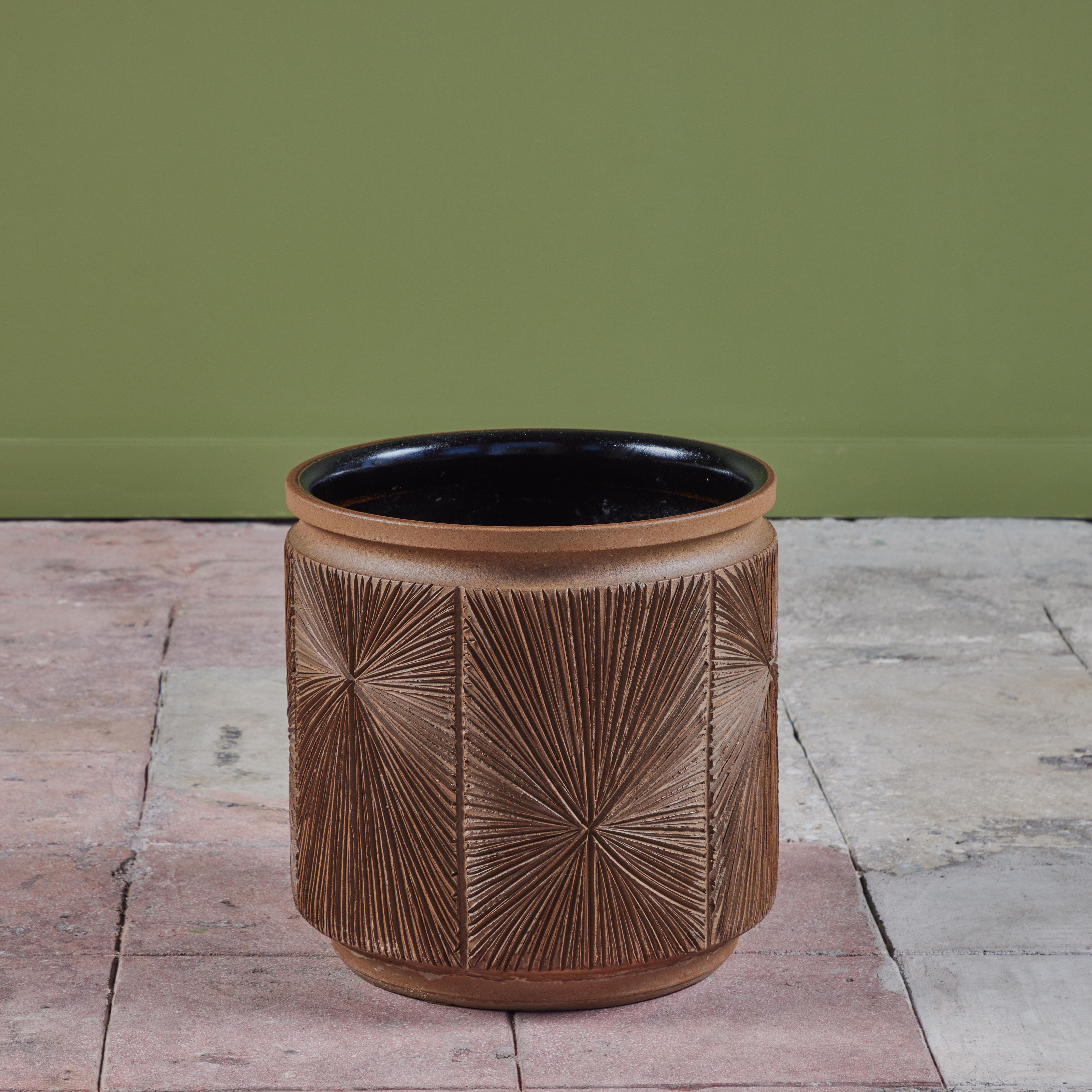 Stoneware planter from Earthgender, David Cressey and Robert Maxwell’s early 1970s project. This 15” diameter example is incised in the “Sunburst” design, a pattern of lines radiating from a central point. The interior of the planter is black