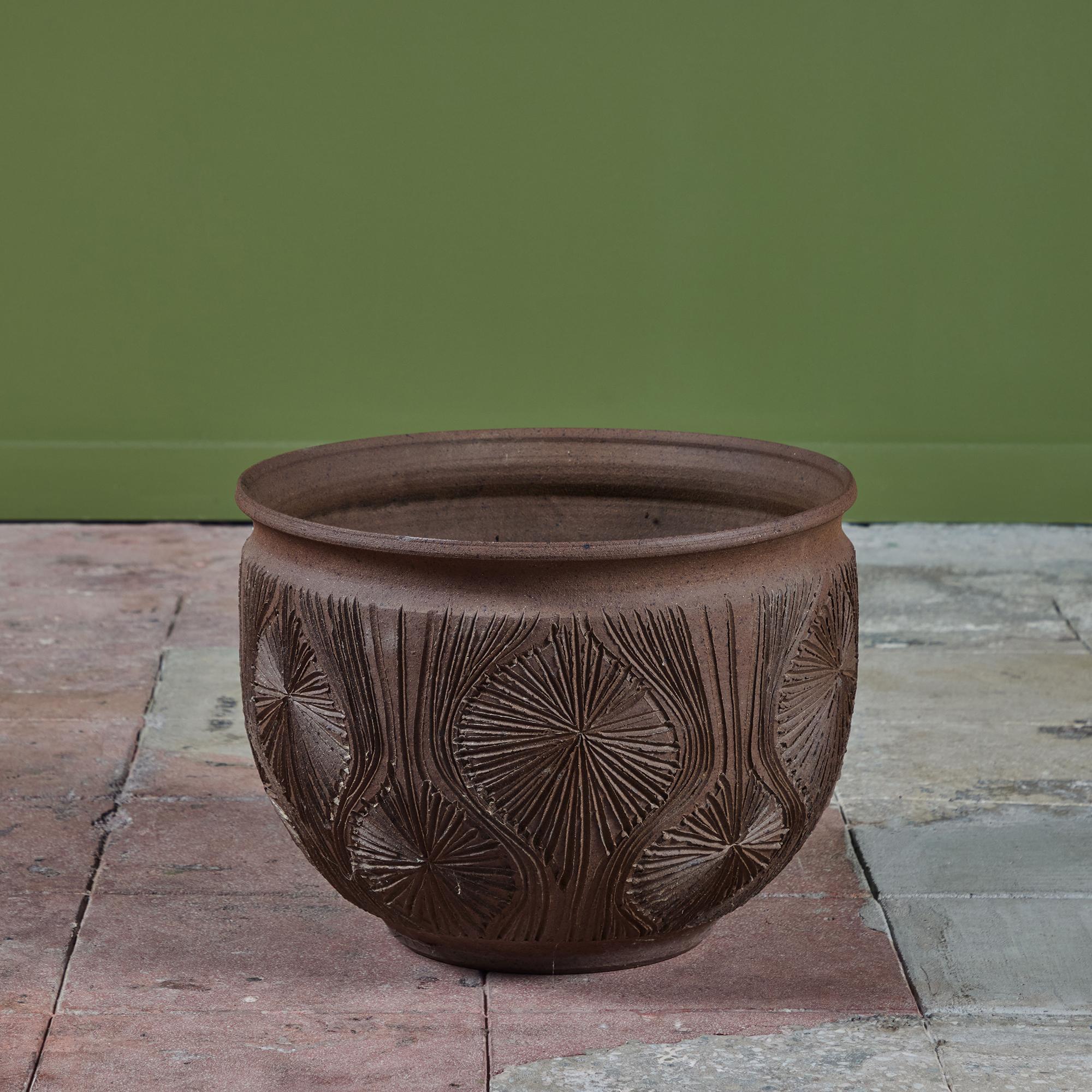 Natural warm brown stoneware planter, c.1970, USA, is a result of the collaboration between David Cressey & Robert Maxwell to create the line Earthgender. This planter features a rounded lip and an incised all-over 