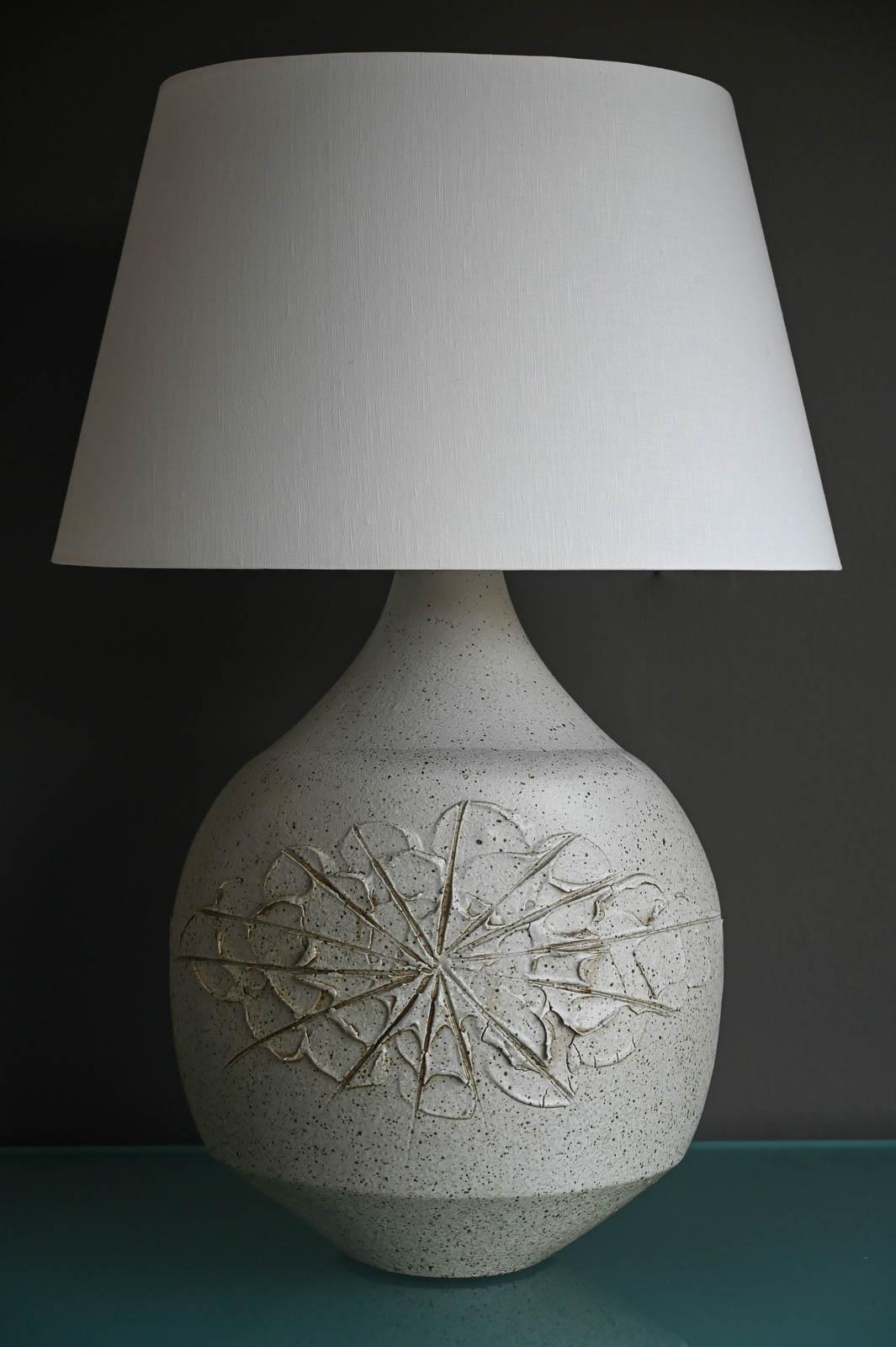 David Cressey 'Solar' Ceramic Lamp, ca. 1970.  Beautiful grey speckled glazed Solar pattern, one of his most desirable designs in this lamp.  Excellent vintage condition with new lamp wiring and fixtures.  Includes lampshade.  

Measures 16